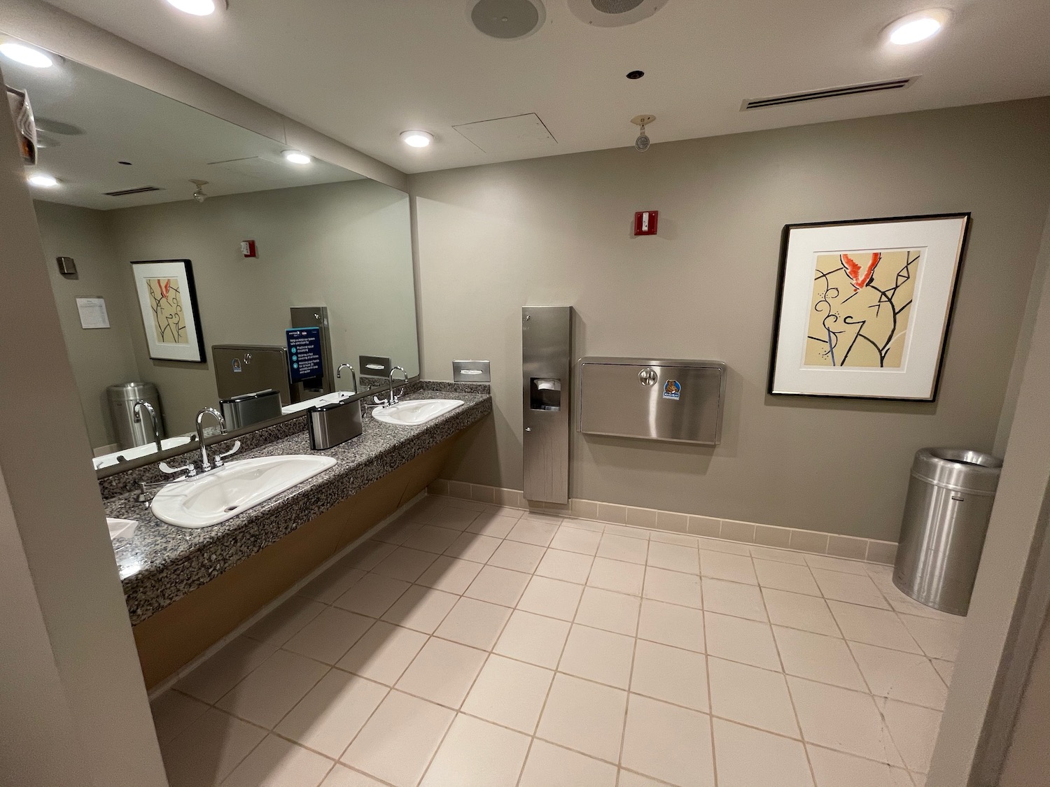 a bathroom with sinks and urinals