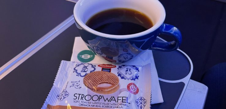 a cup of coffee and a packet of stroopwafel