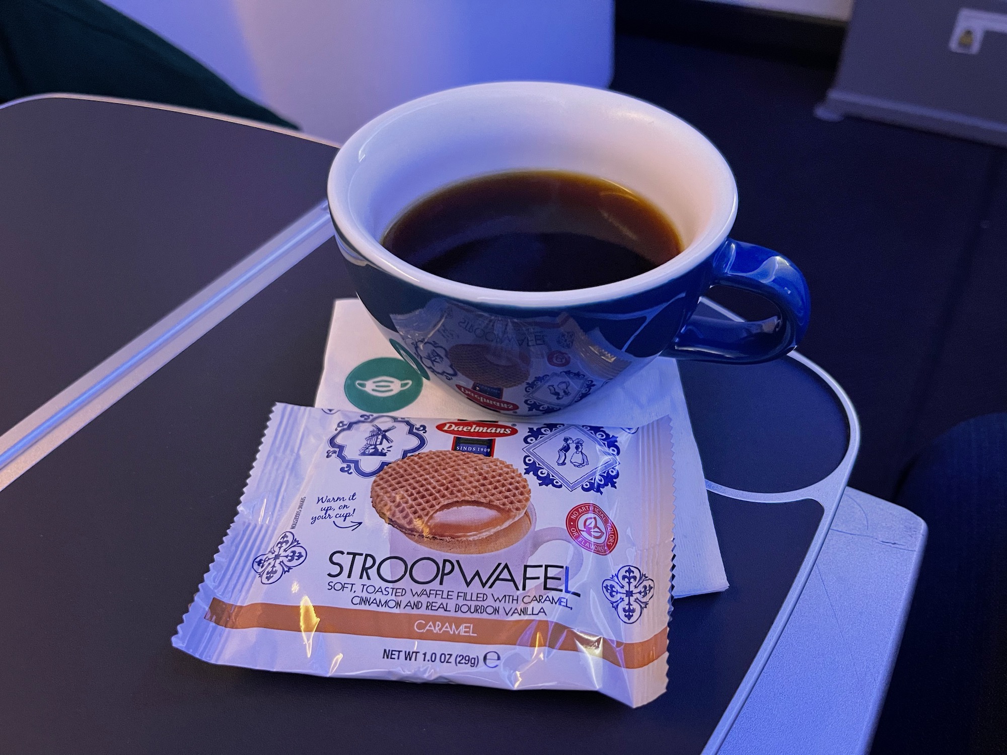 a cup of coffee and a packet of stroopwafel