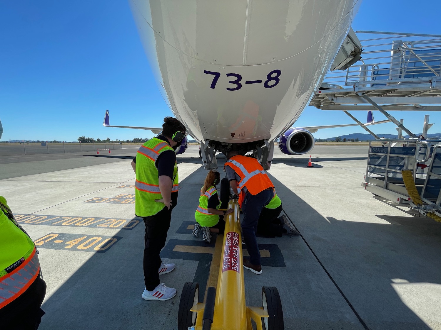 a group of people working on an airplane