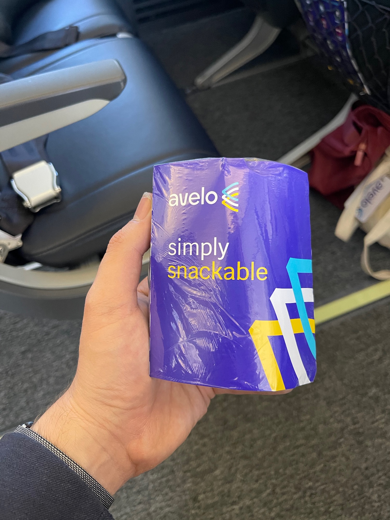 a hand holding a blue plastic container