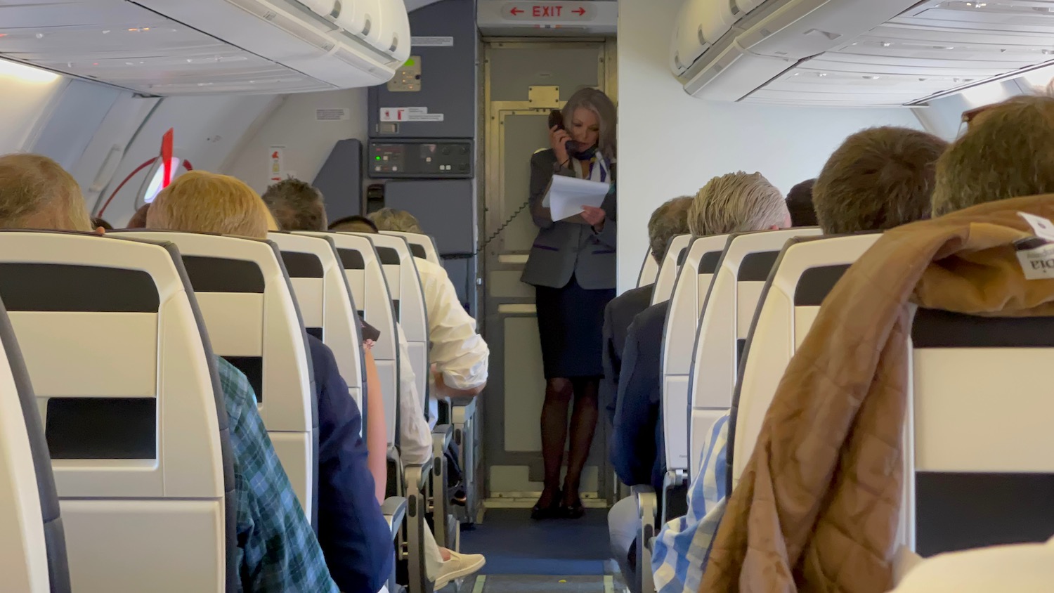 a woman standing in an airplane