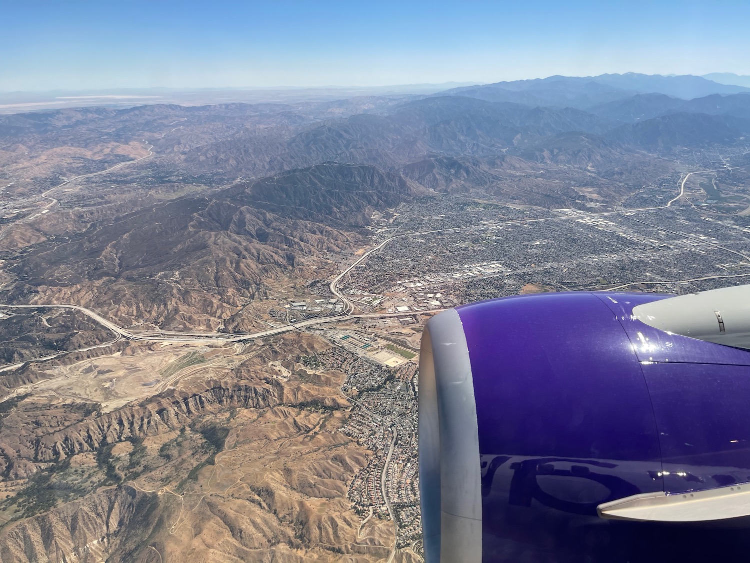 an airplane wing and a city