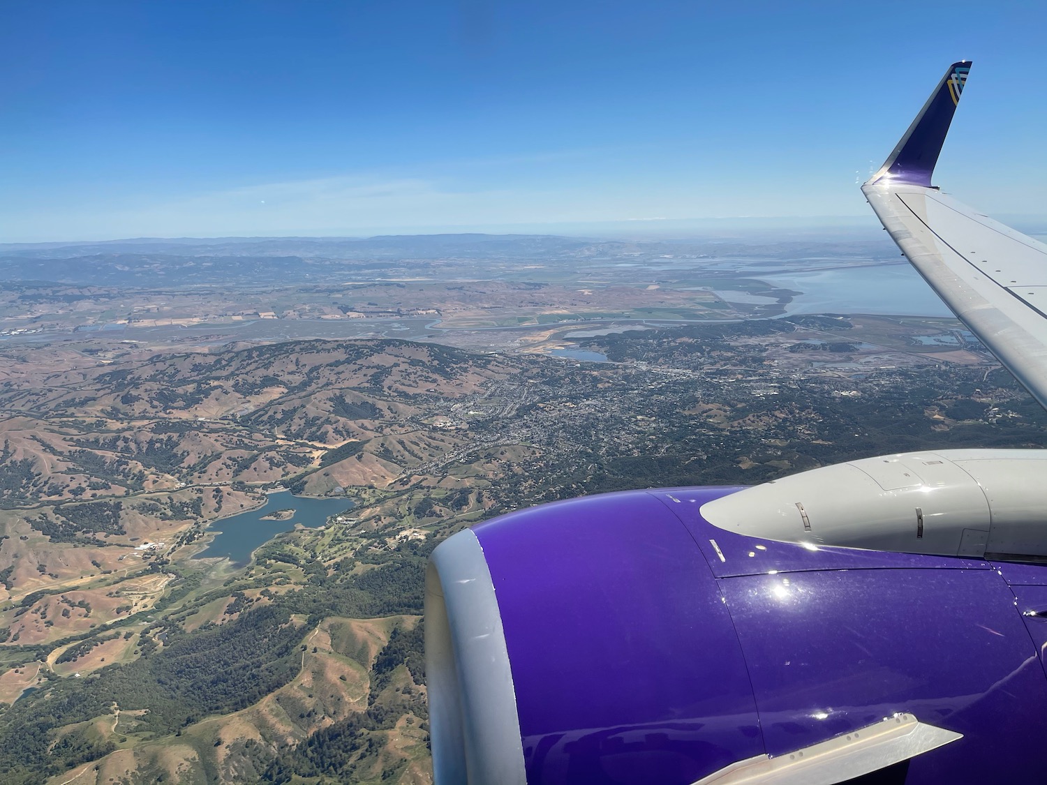 an airplane wing and a landscape