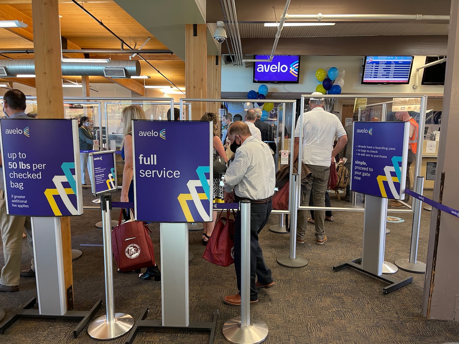 a group of people standing in line at a check in area