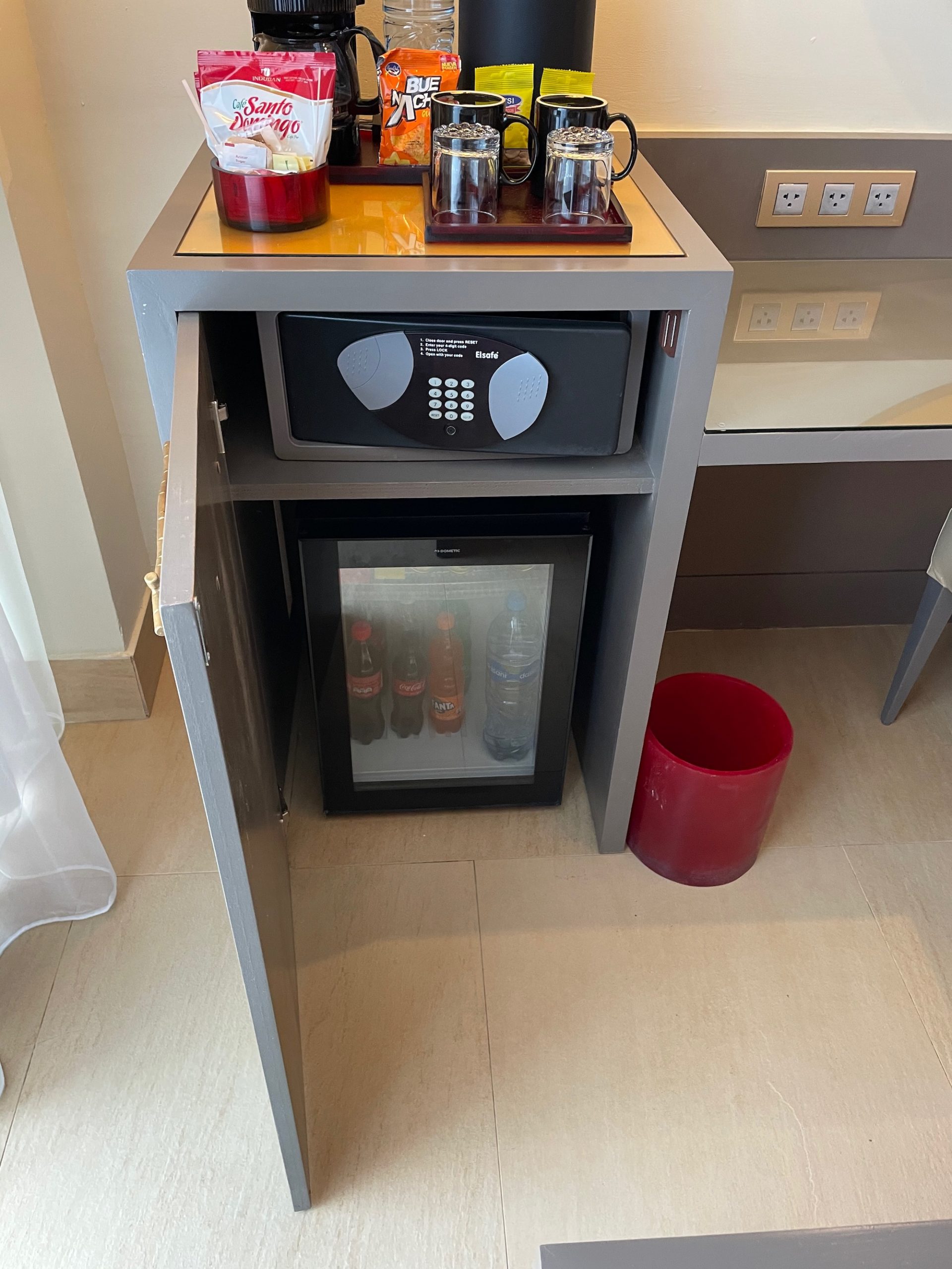 a small cabinet with a microwave and a small refrigerator