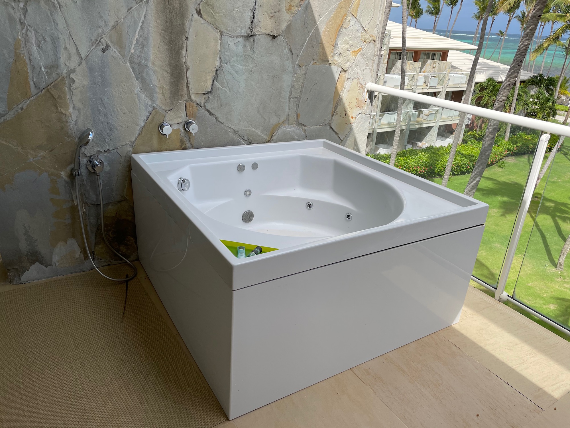 a white bathtub on a balcony