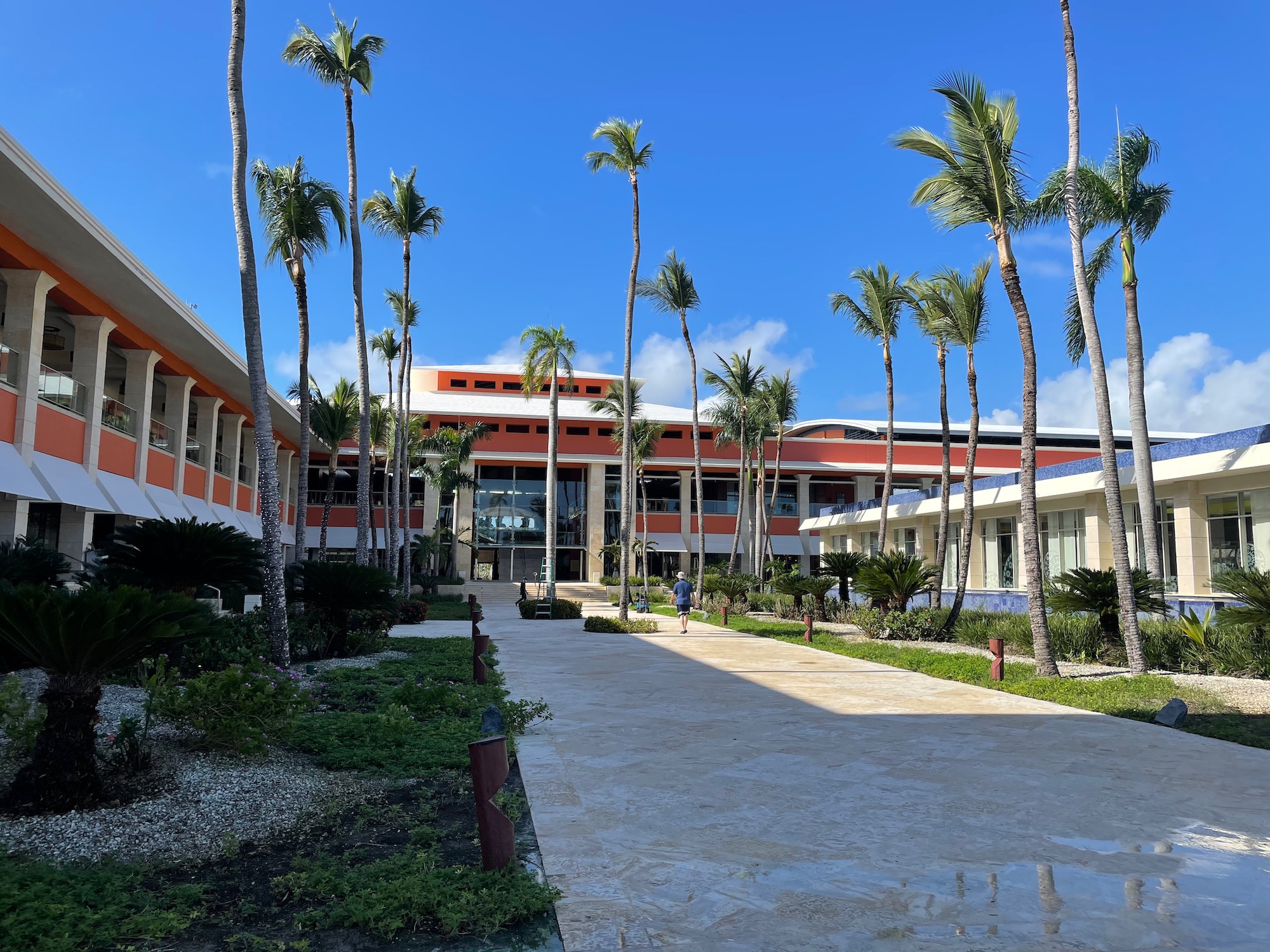 a building with palm trees and a walkway