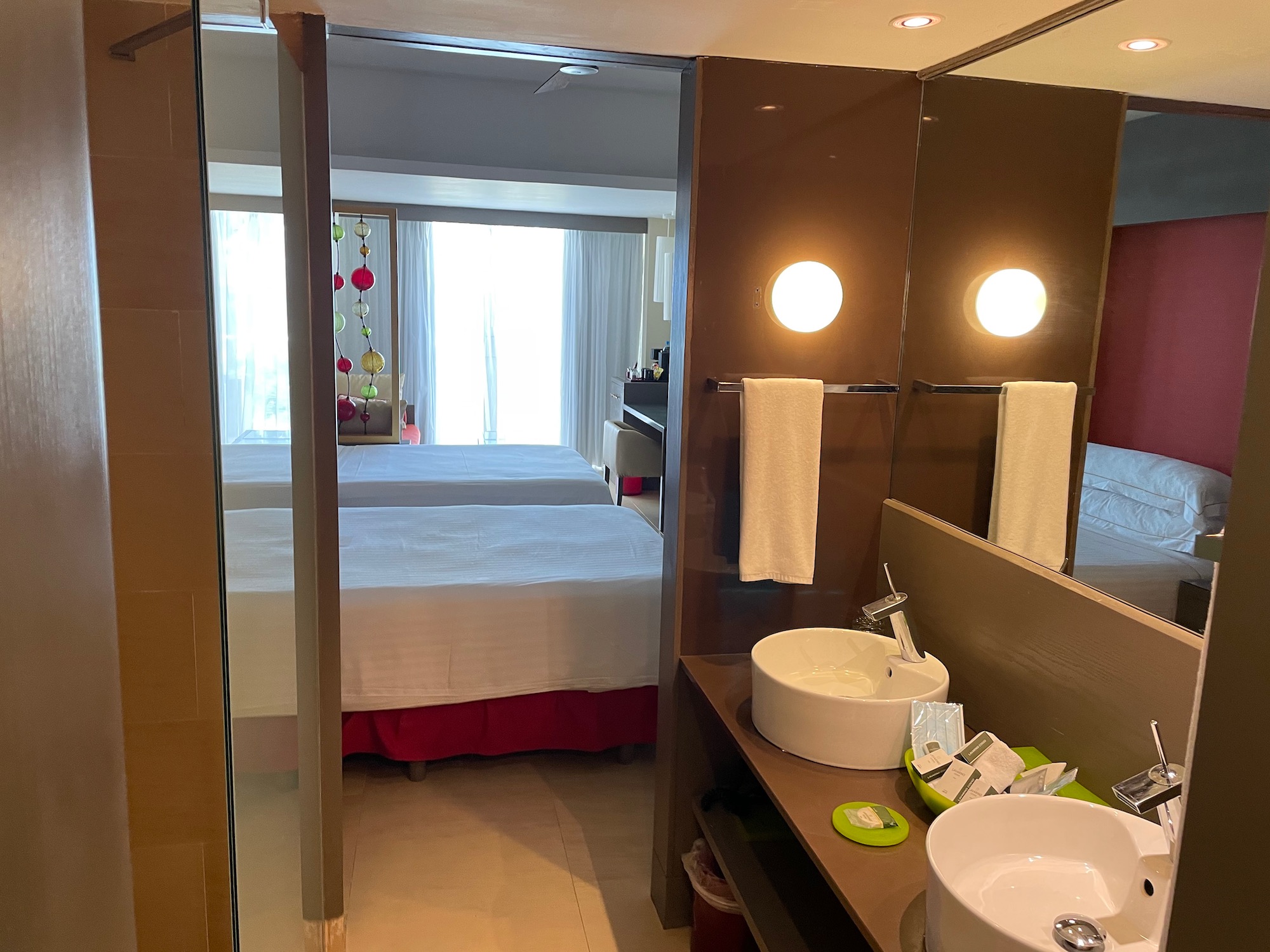 a bathroom with two beds and a sink