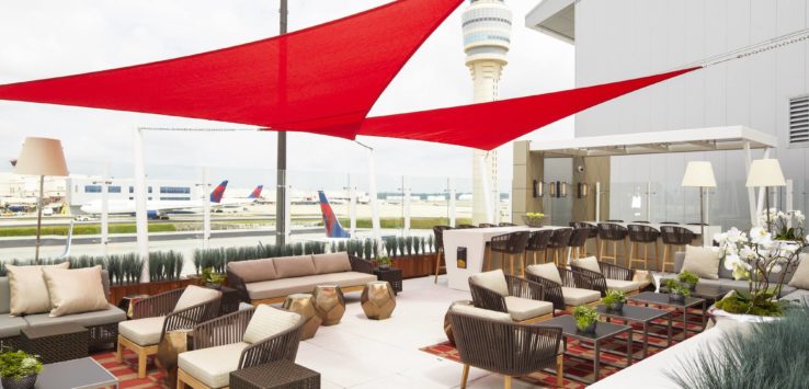 a patio with a red awning and chairs