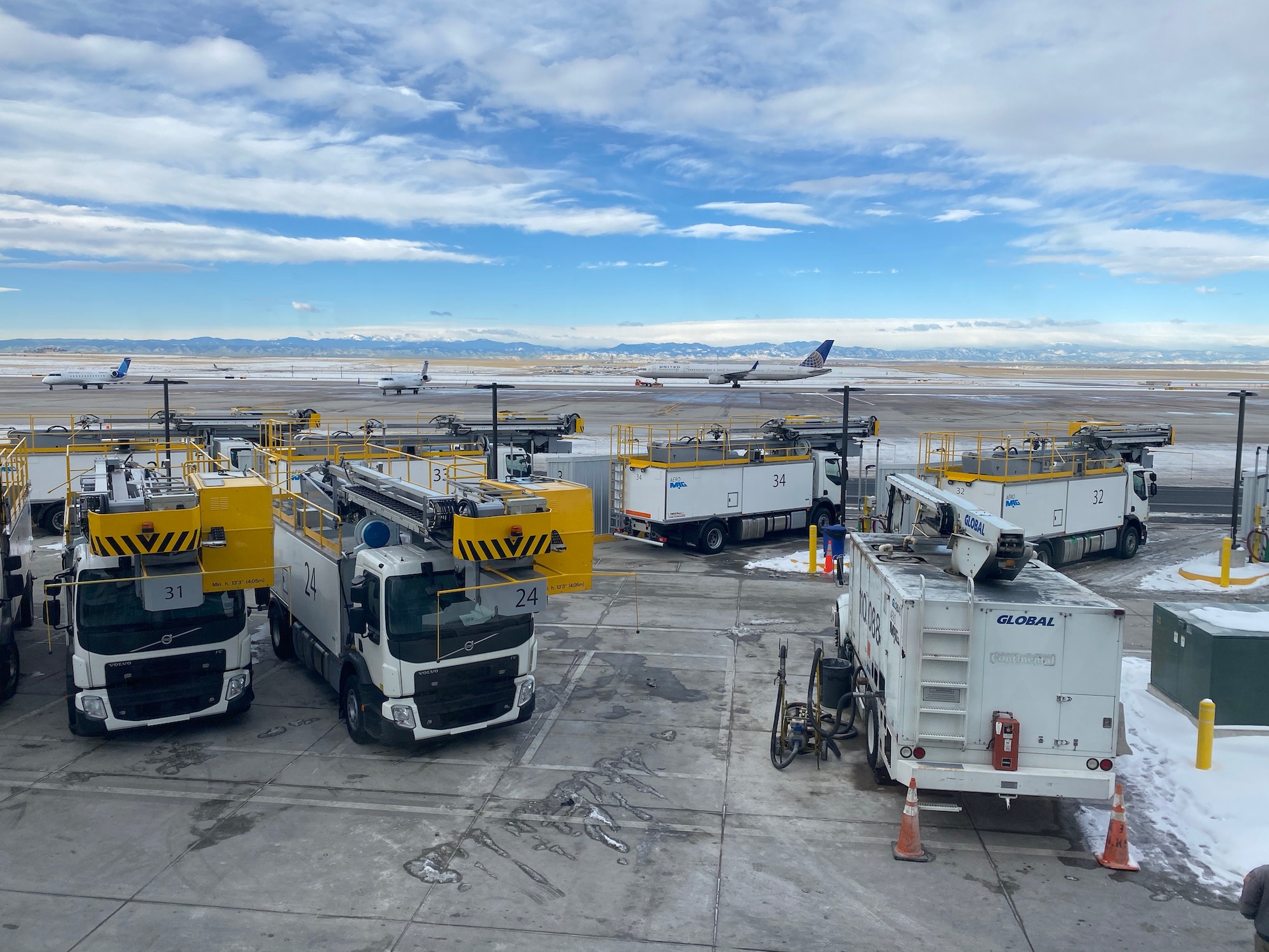 a group of trucks parked on a tarmac