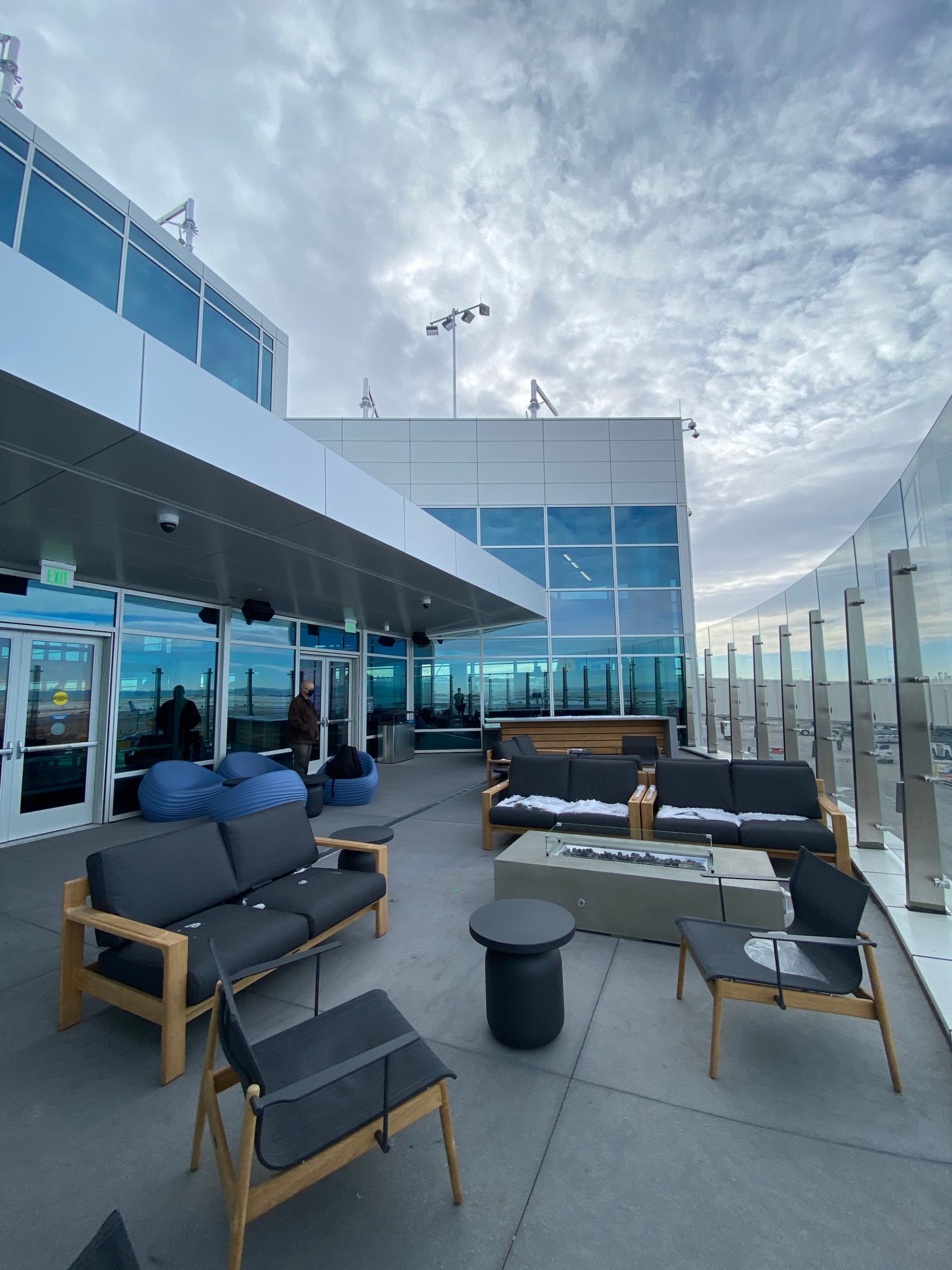 a building with a glass wall and a group of chairs