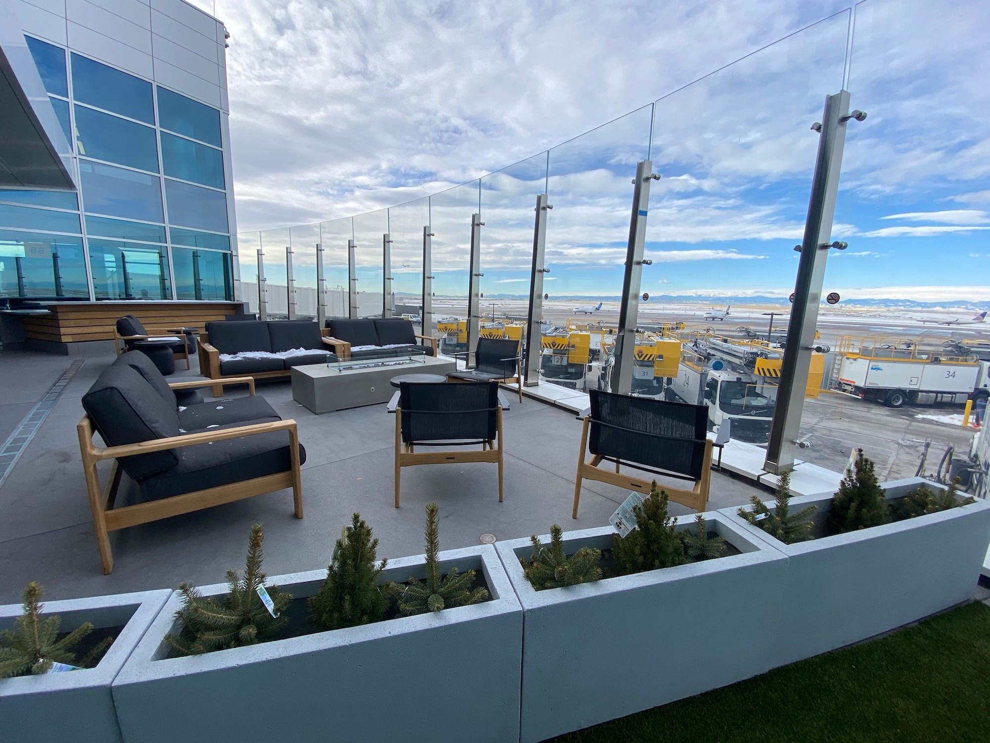 a rooftop patio with chairs and a table