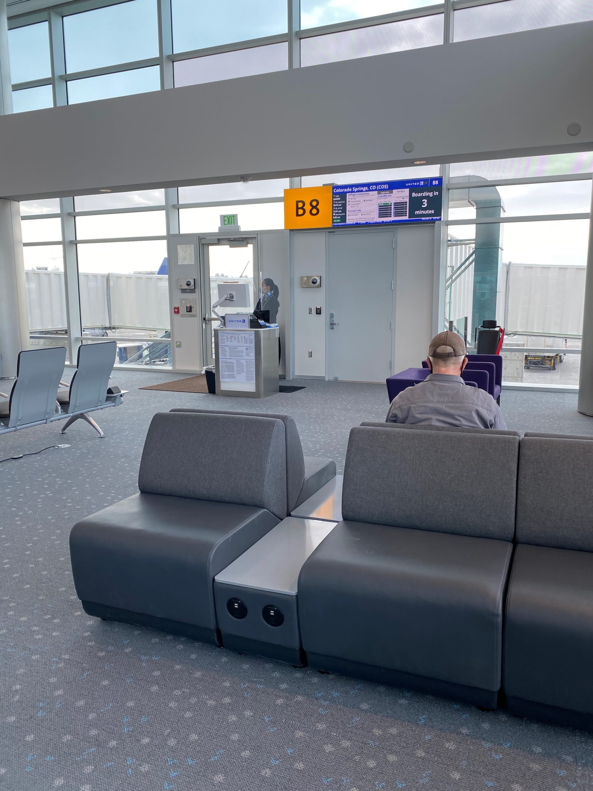 a man sitting in a chair in an airport