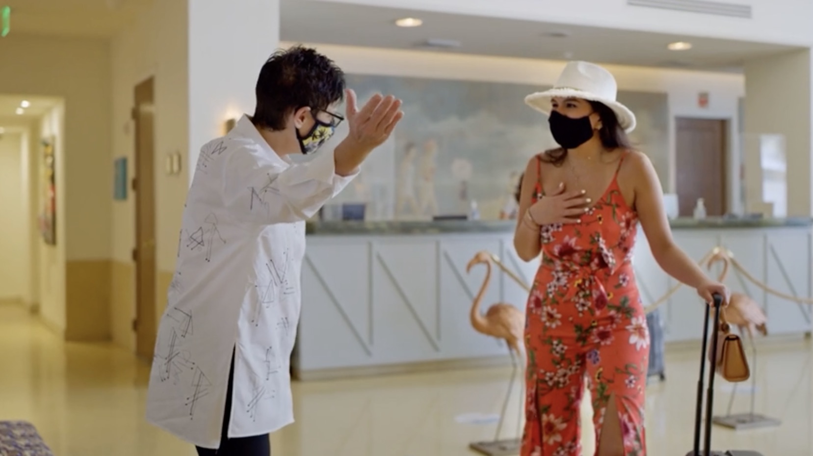 a man and woman wearing face masks