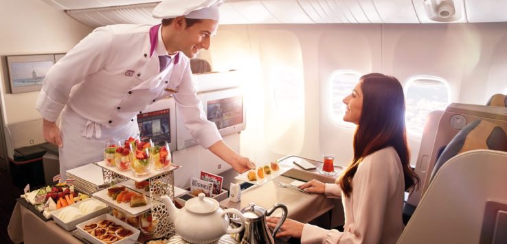 a chef serving food to a woman