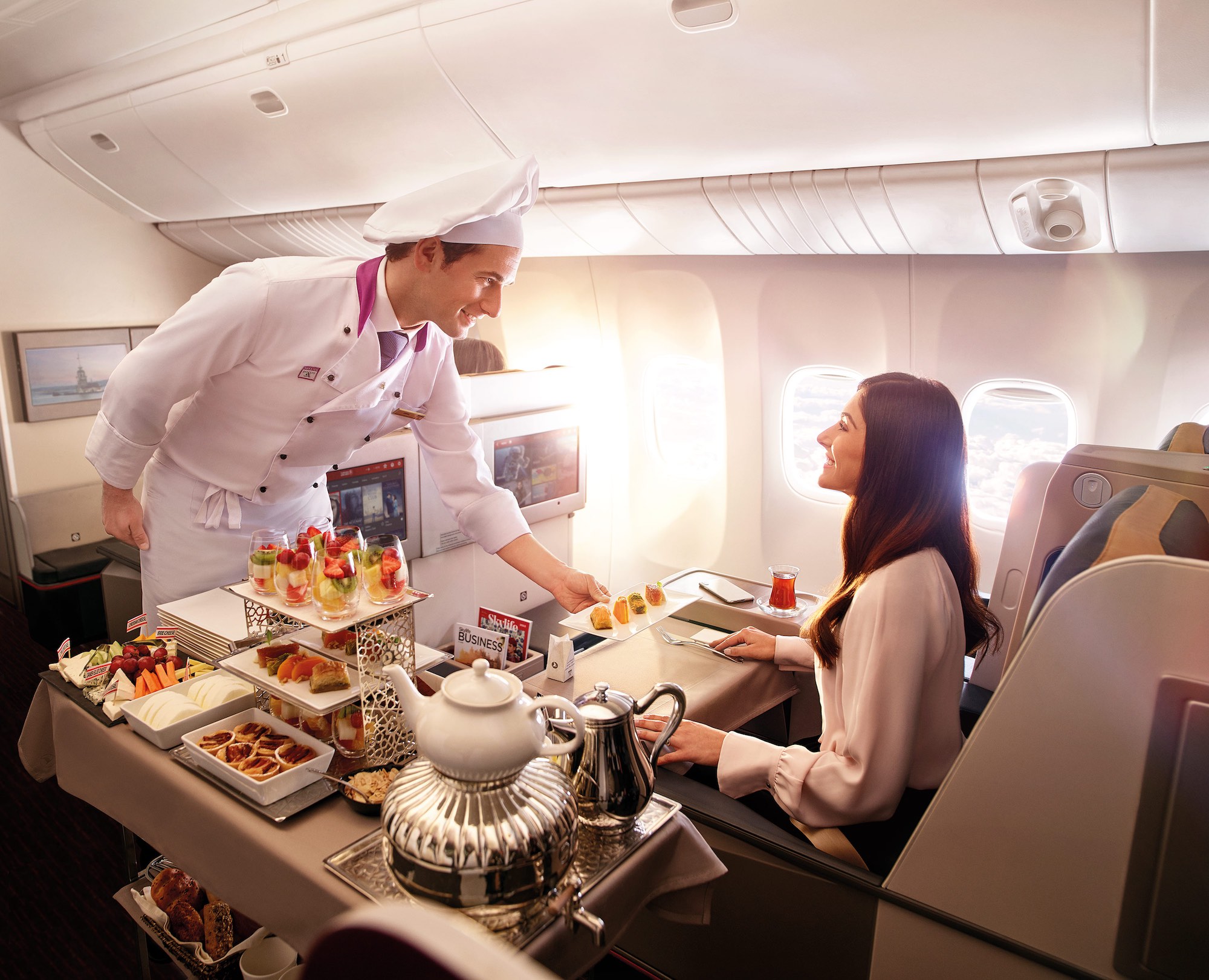 a chef serving food to a woman