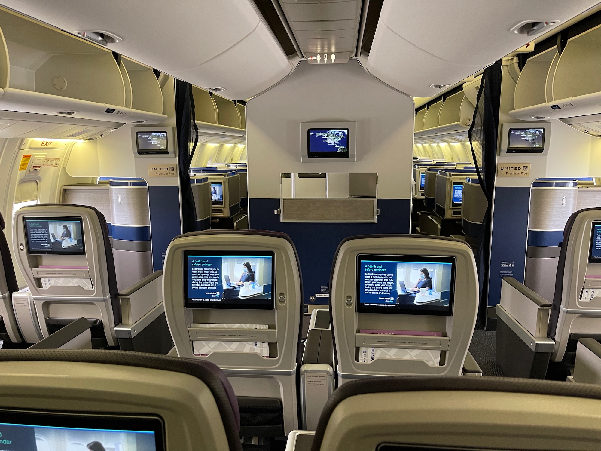 a row of seats with monitors on the side