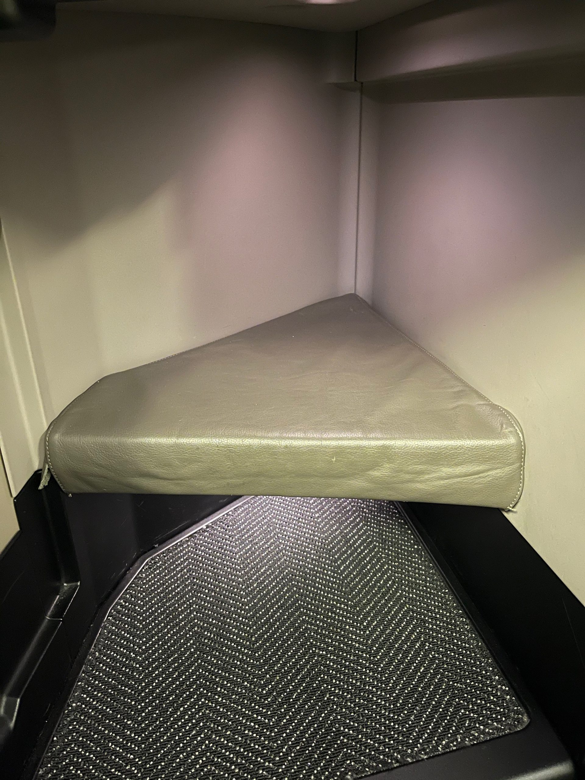 a corner of a room with a seat