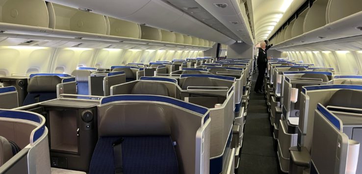 an airplane with seats and a person standing in the middle