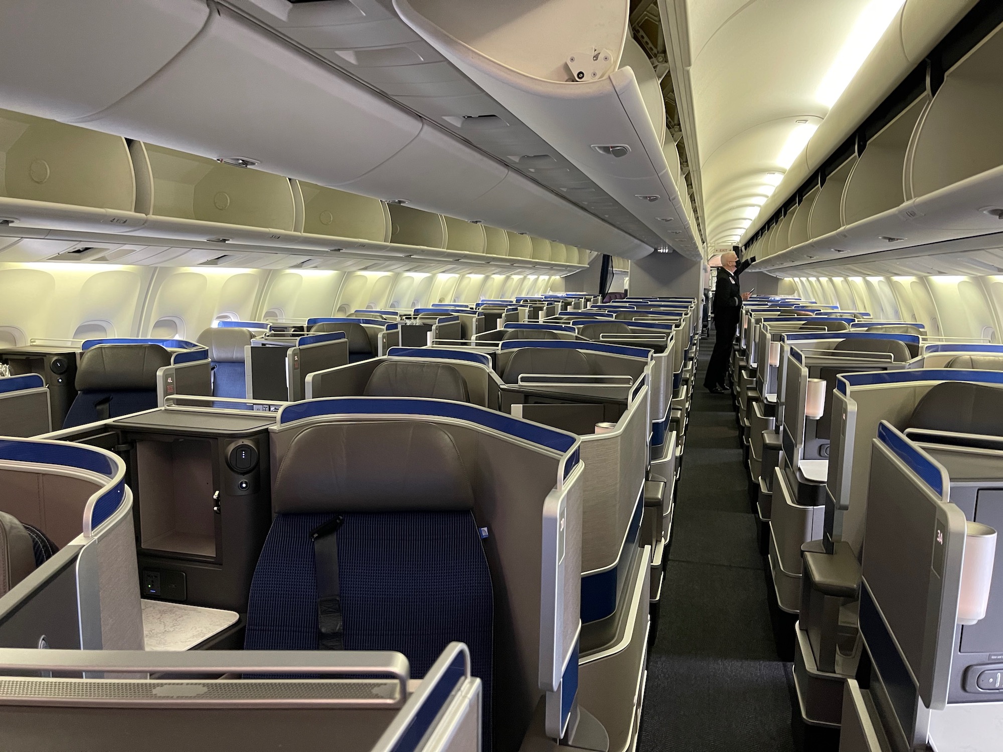 an airplane with seats and a person standing in the middle