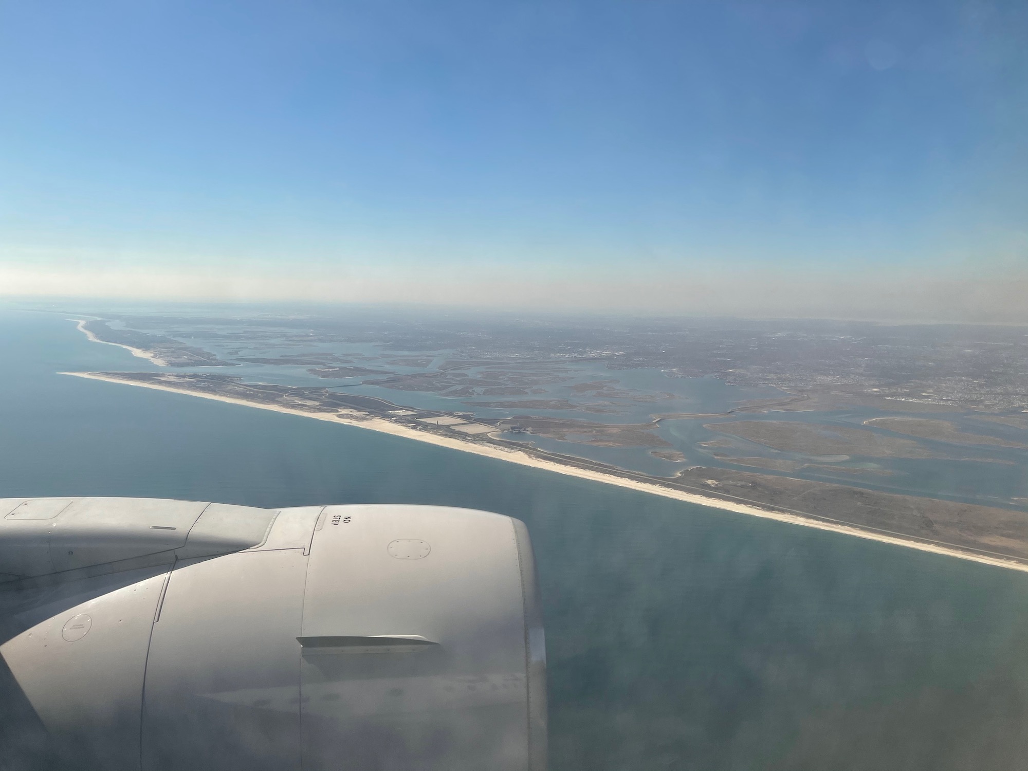 an airplane wing and a body of water