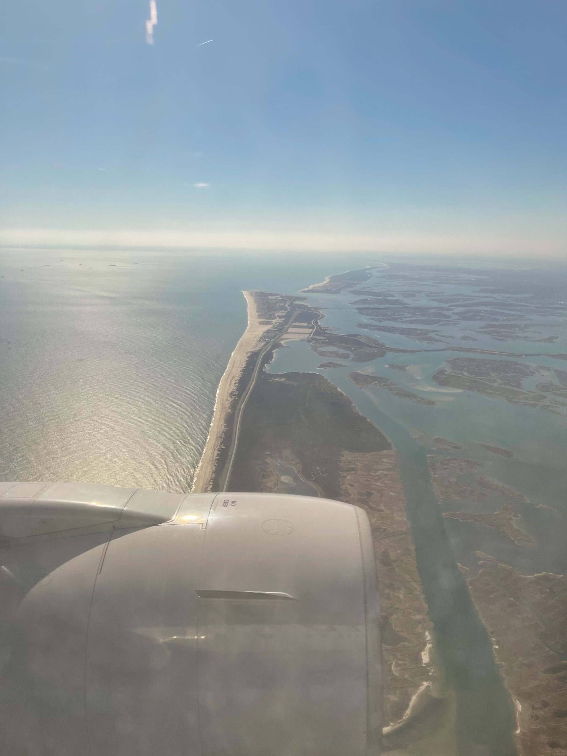 an airplane wing over a body of water