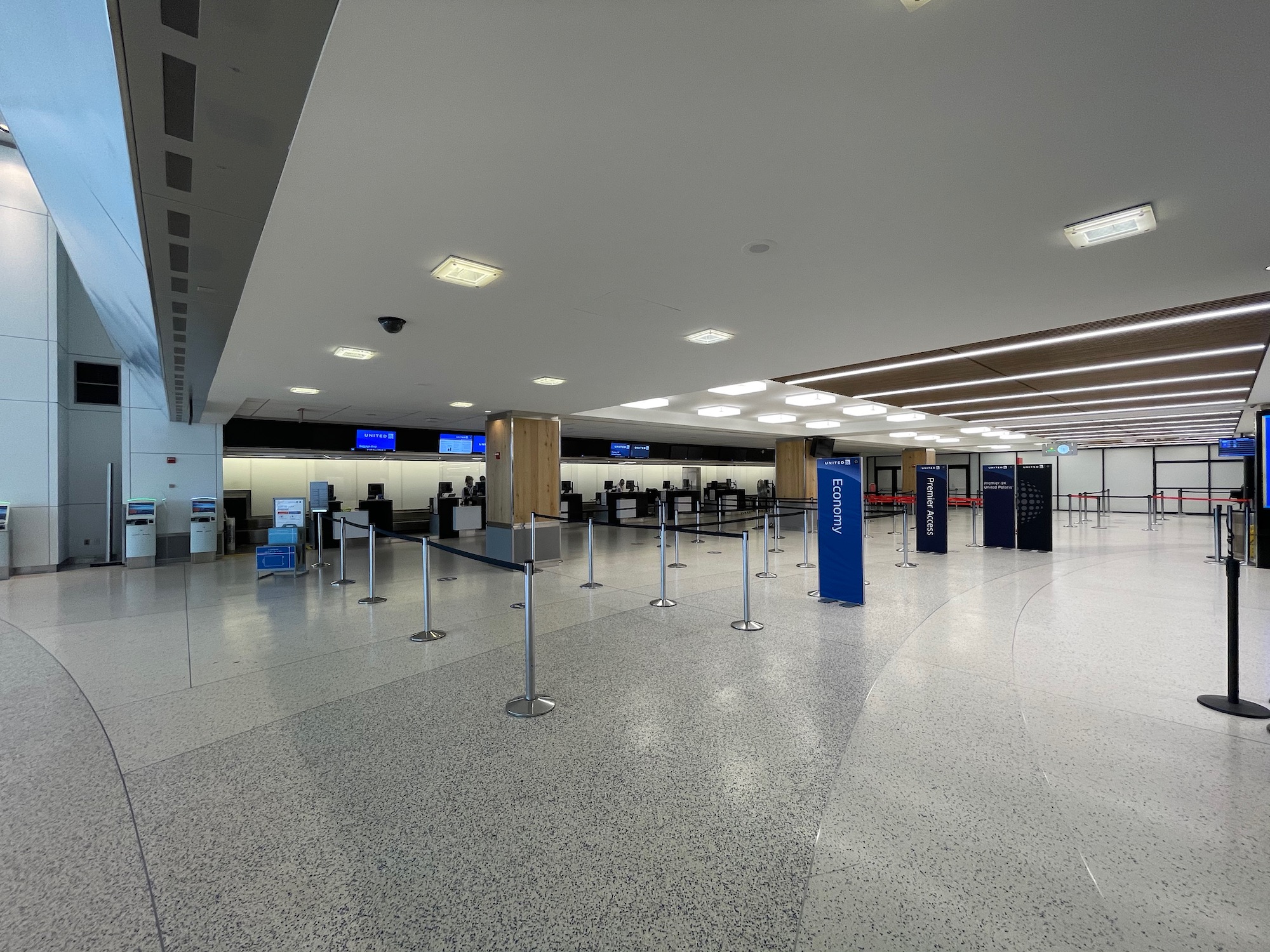 a large airport terminal with a few check in counters