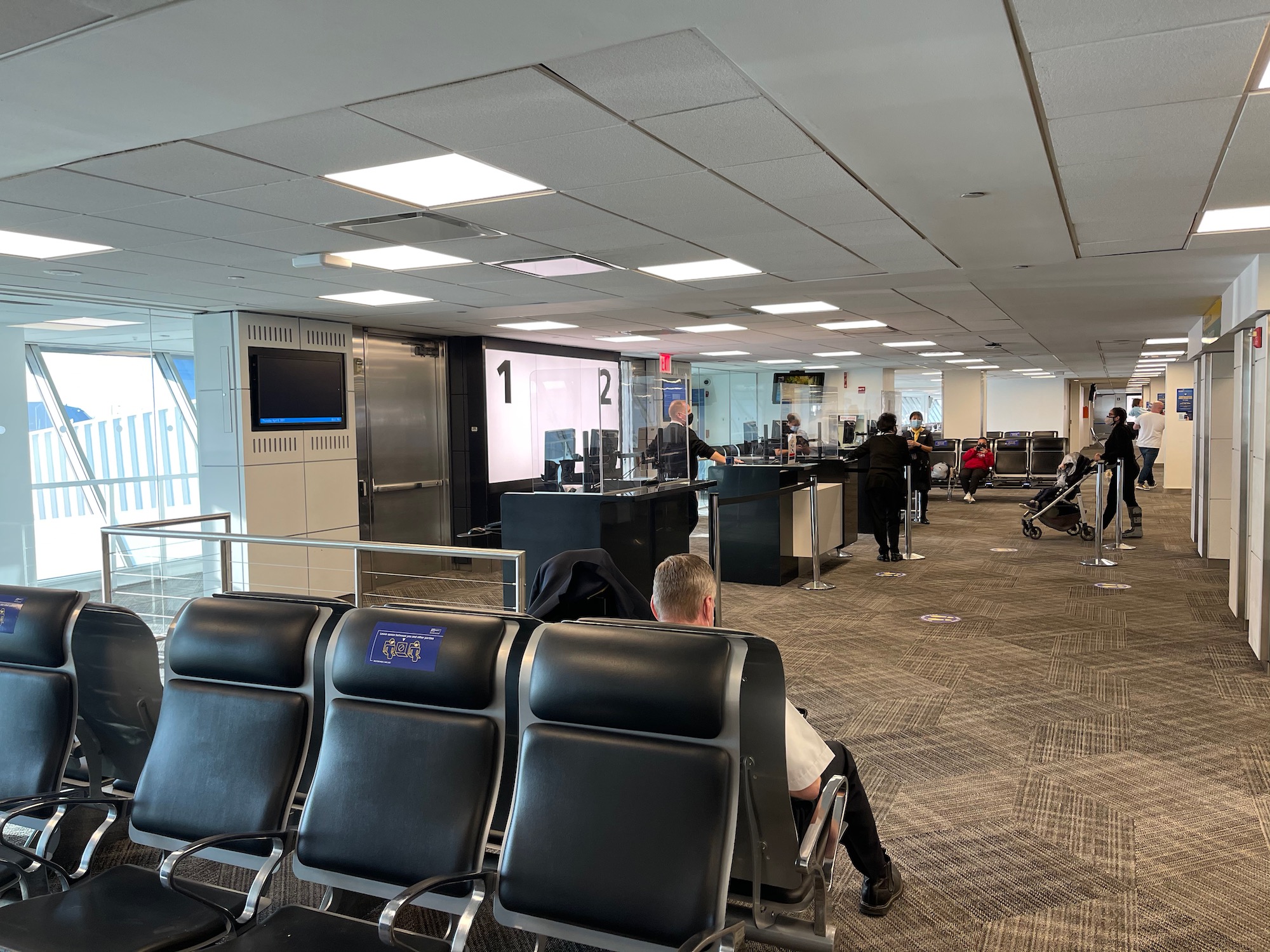 people sitting in an airport waiting area