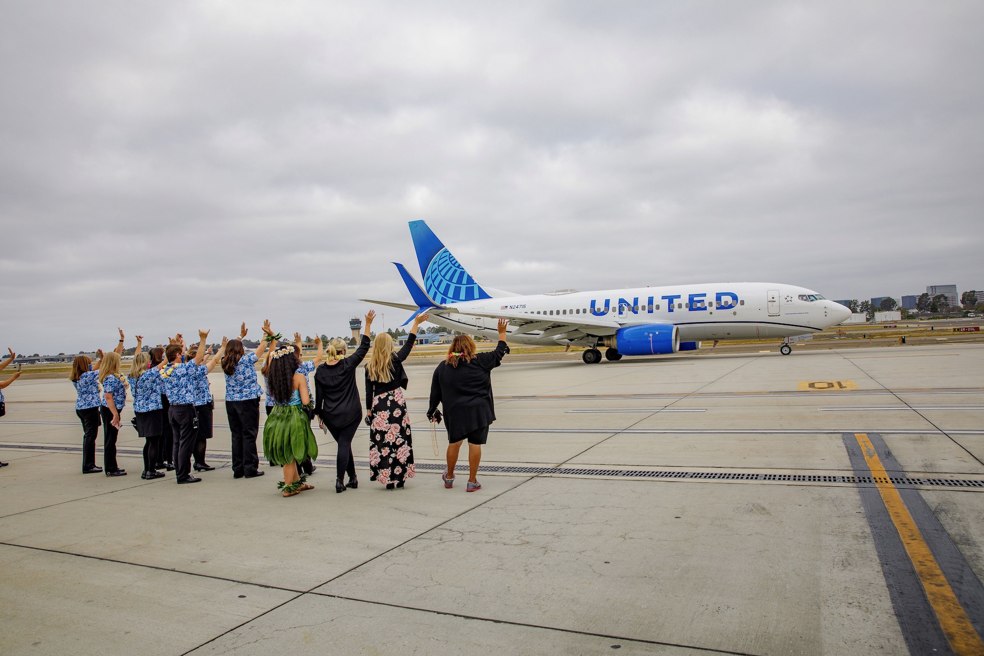 a group of people standing in front of an airplane