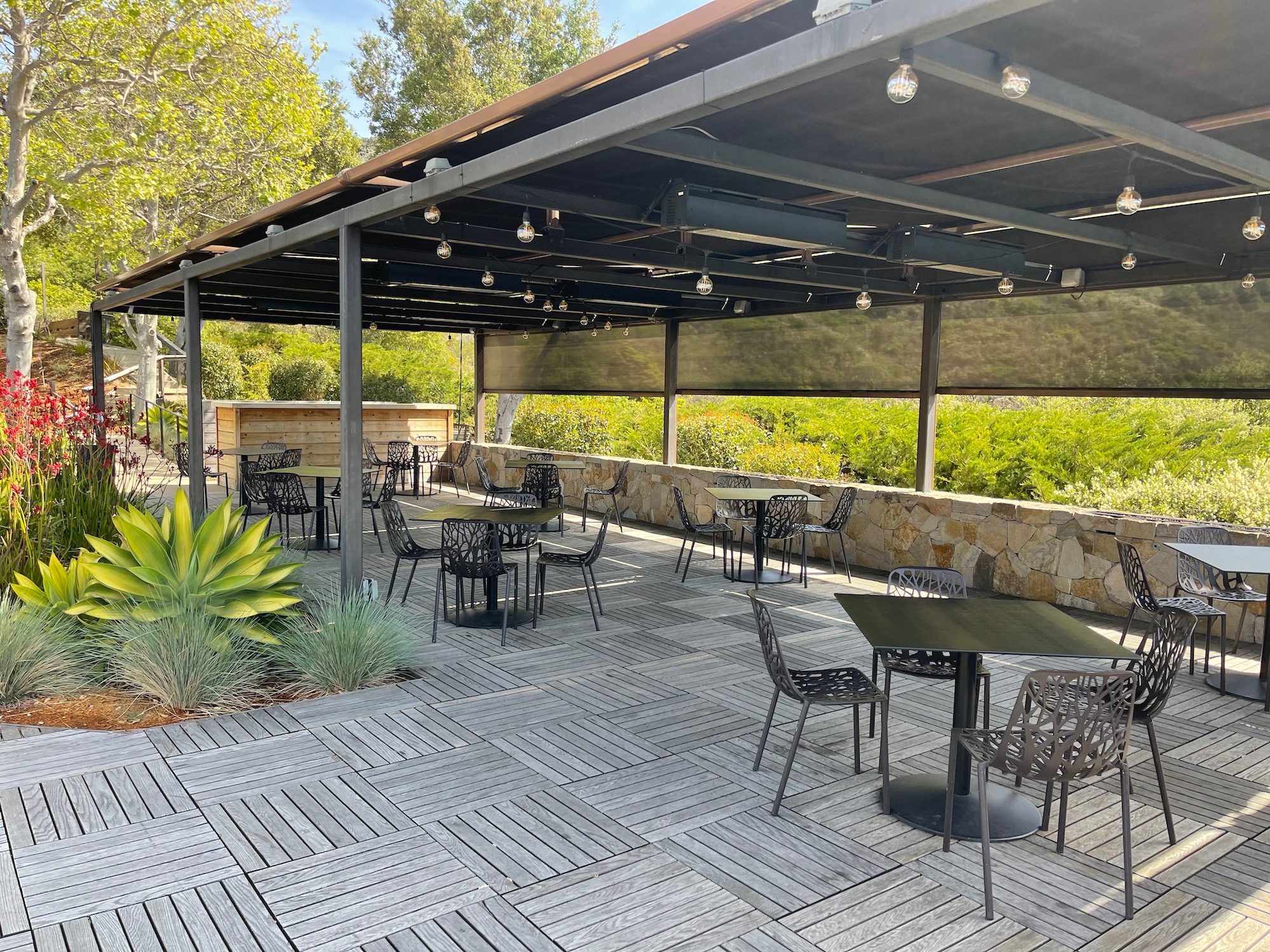 a patio with tables and chairs