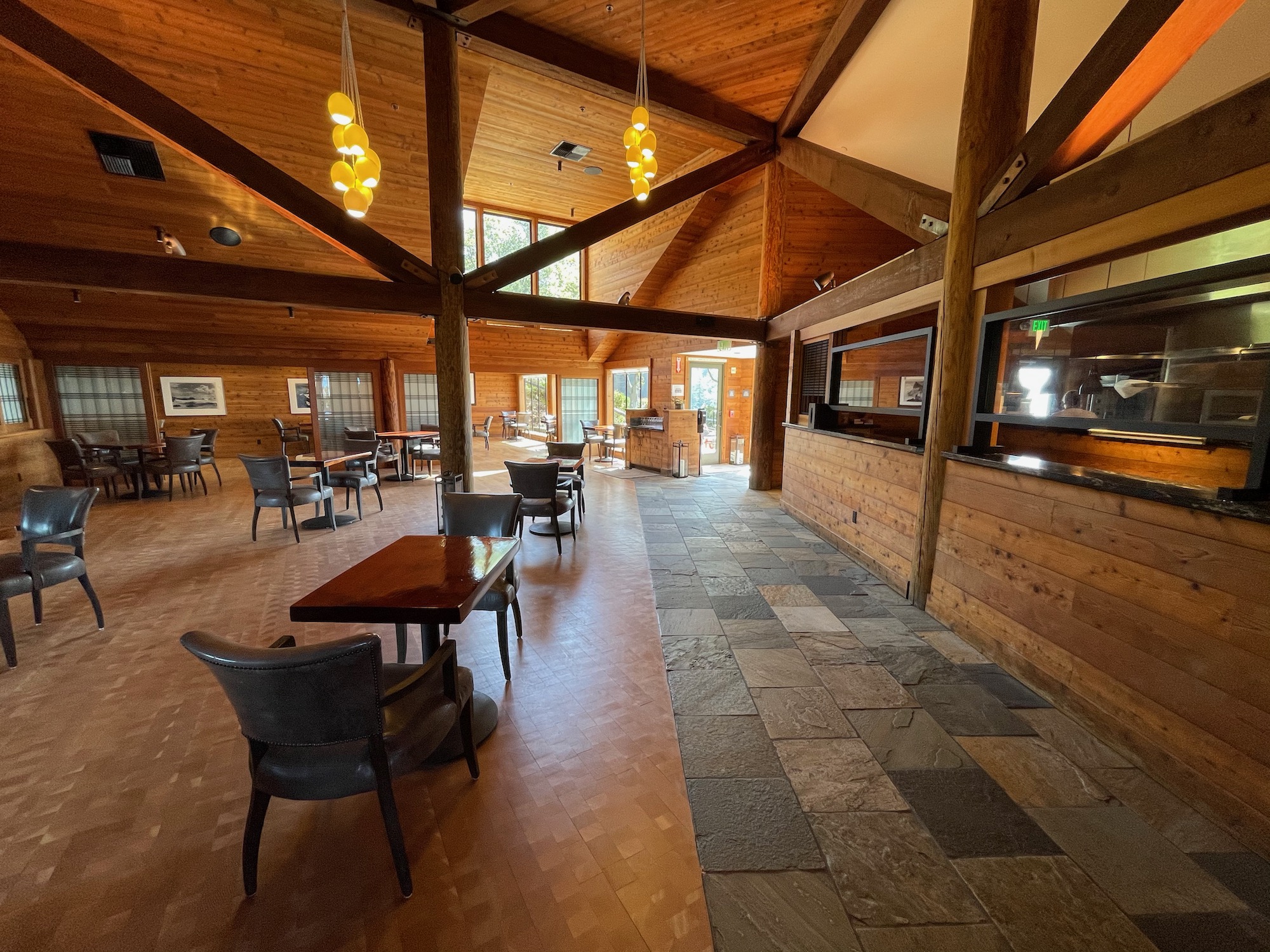 a room with a wood ceiling and a table and chairs