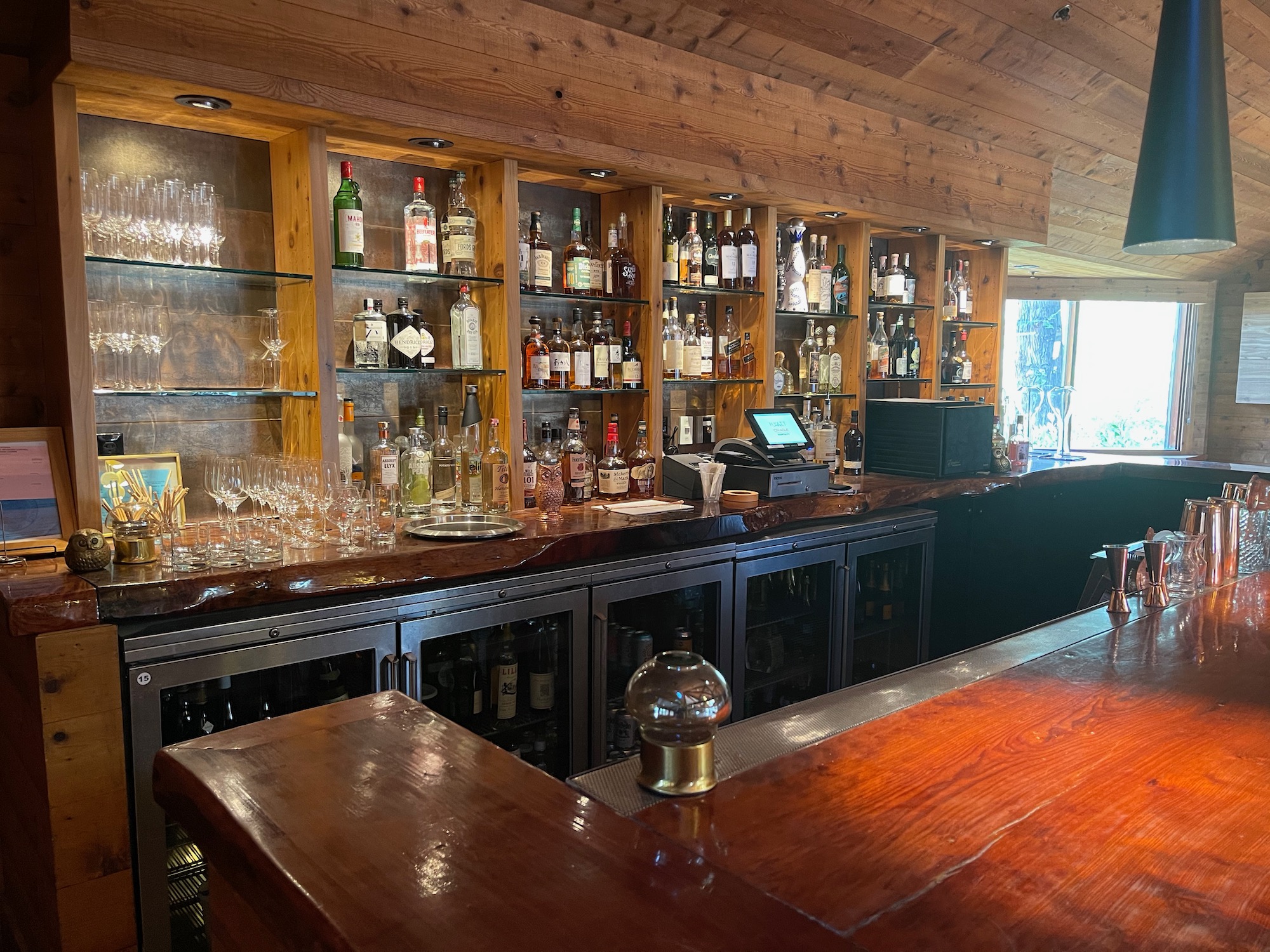 a bar with shelves of liquor and glasses