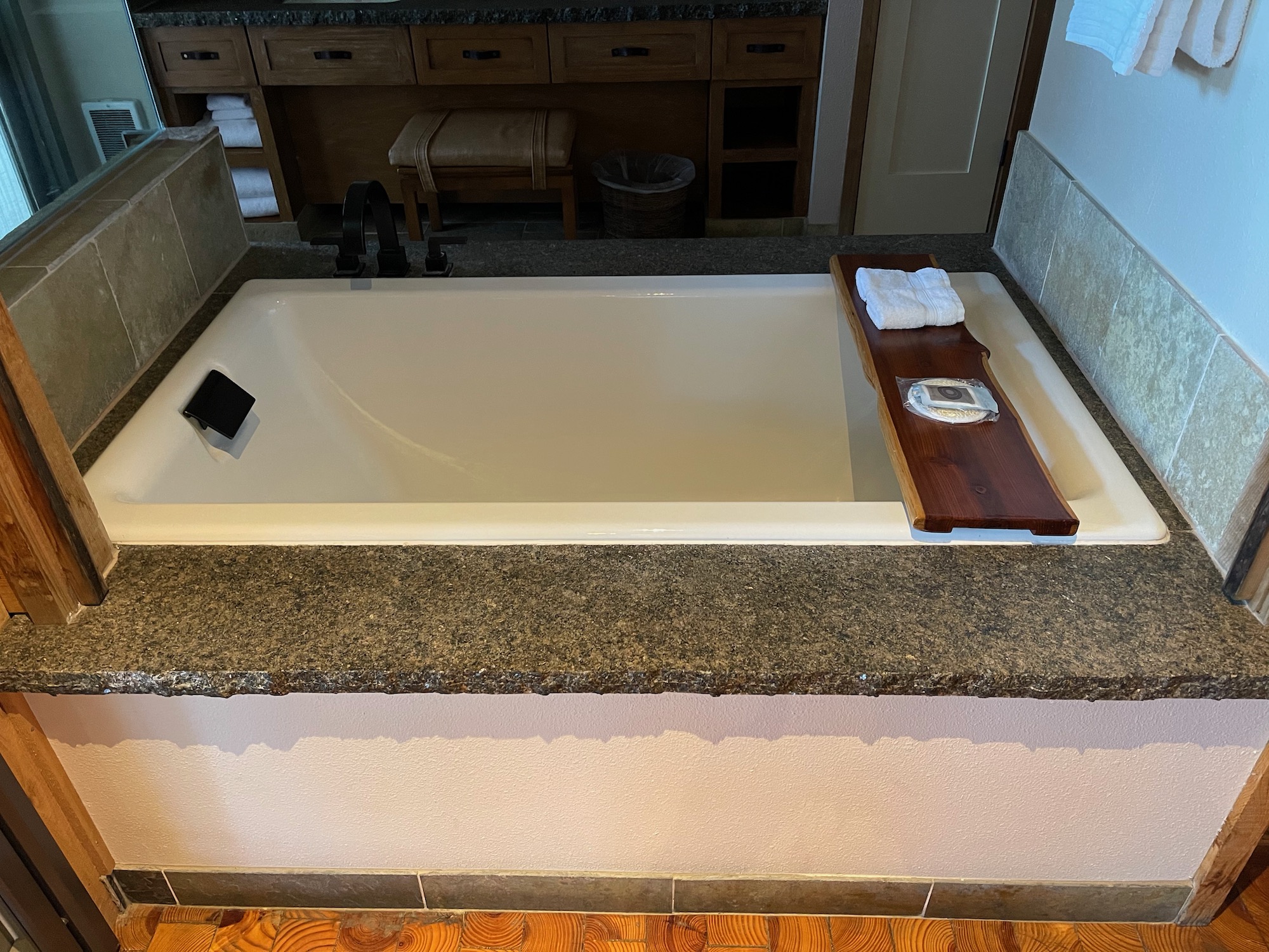a bathtub with a tray on top of it