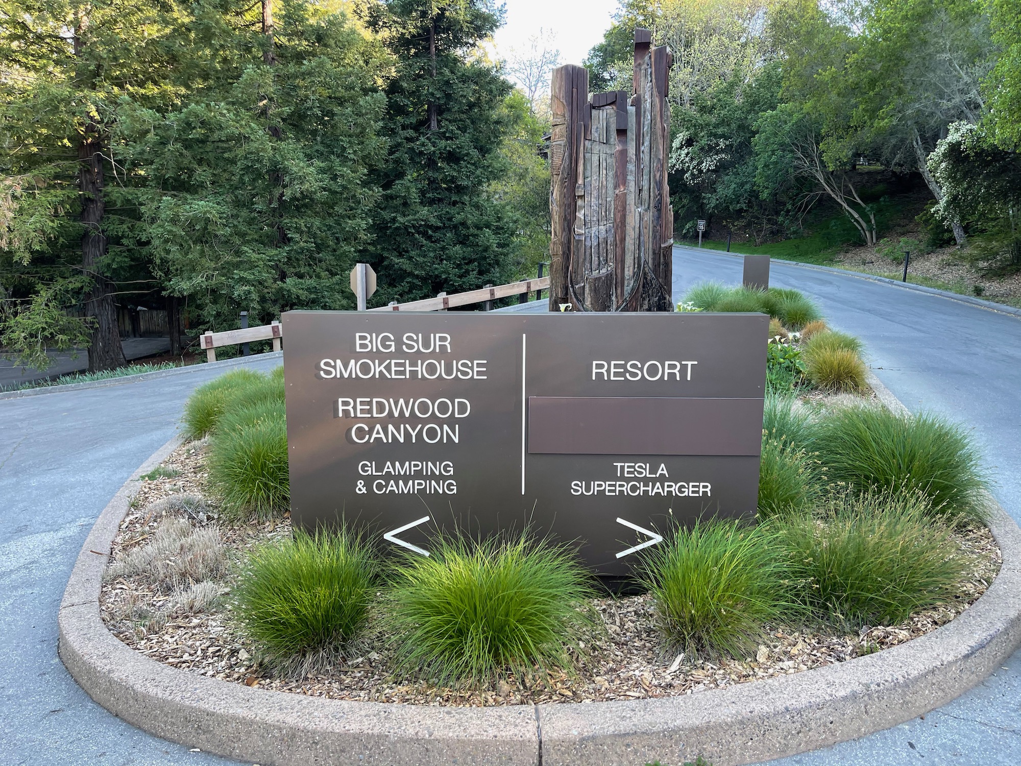 a sign in a circle with grass around it