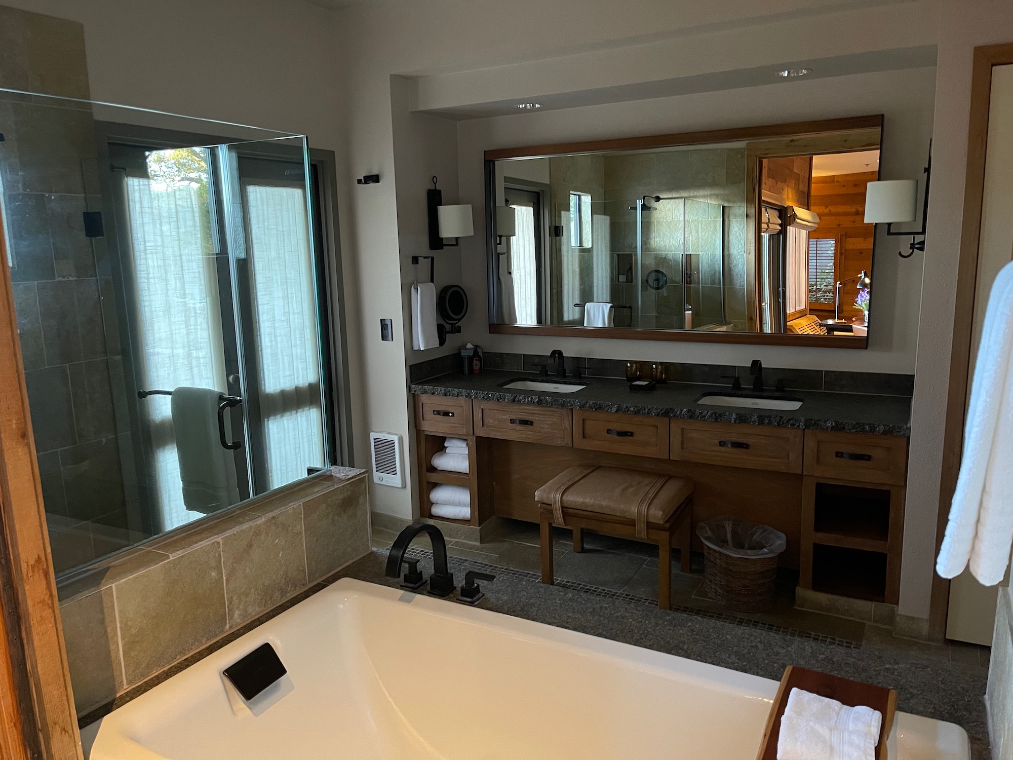 a bathroom with a large mirror and a tub