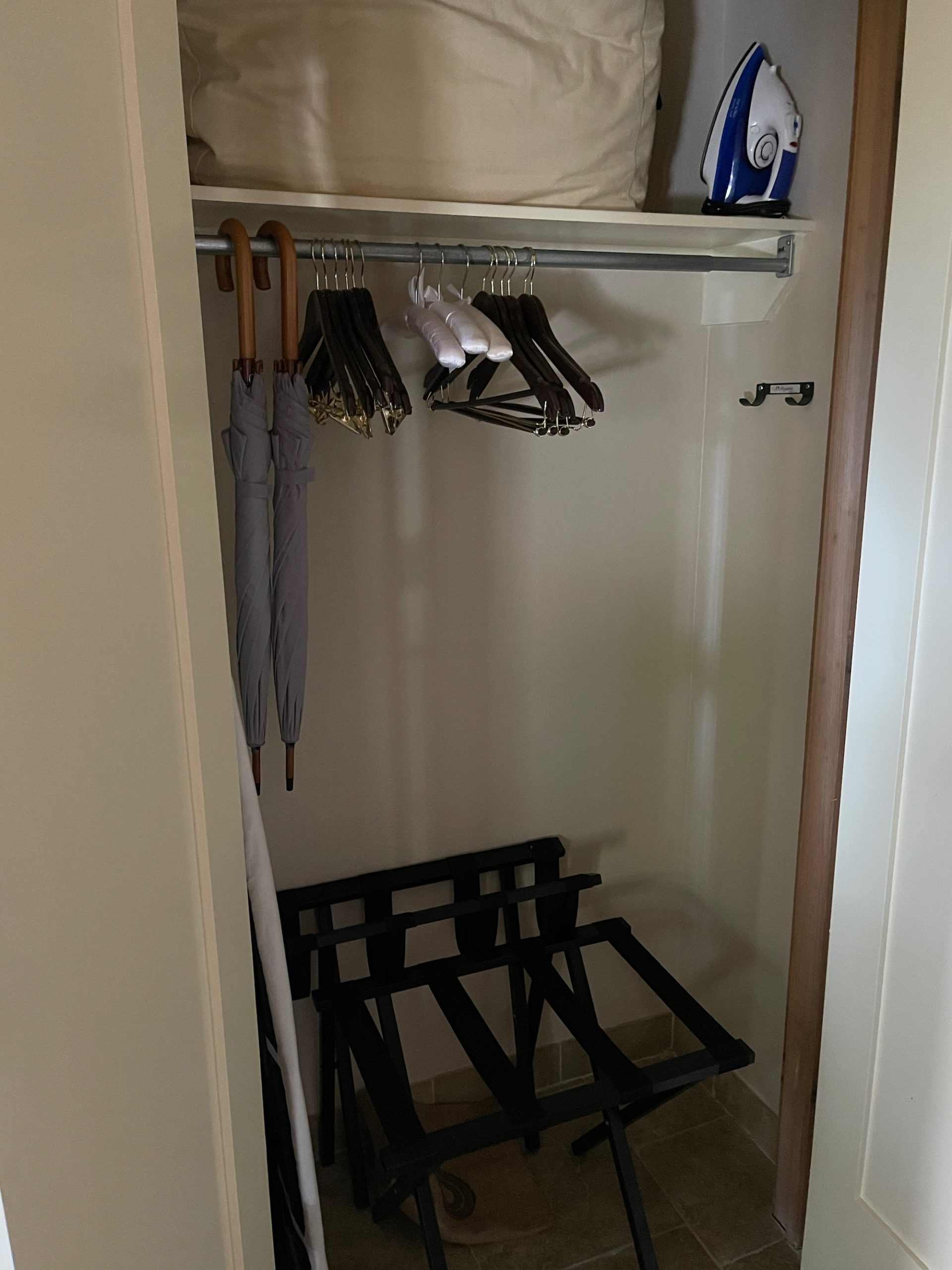 a closet with clothes on a rail