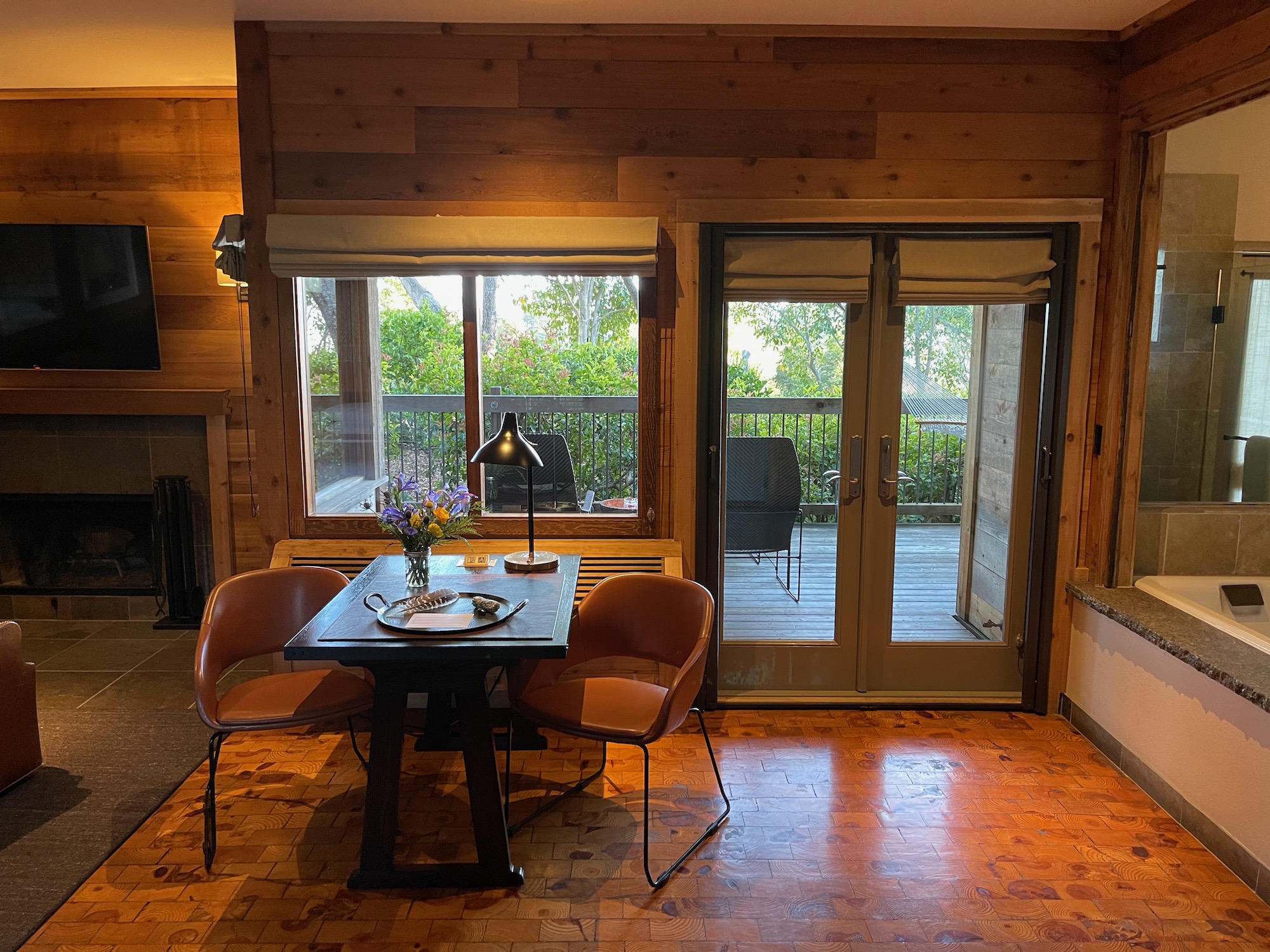 a table with chairs in front of a glass door