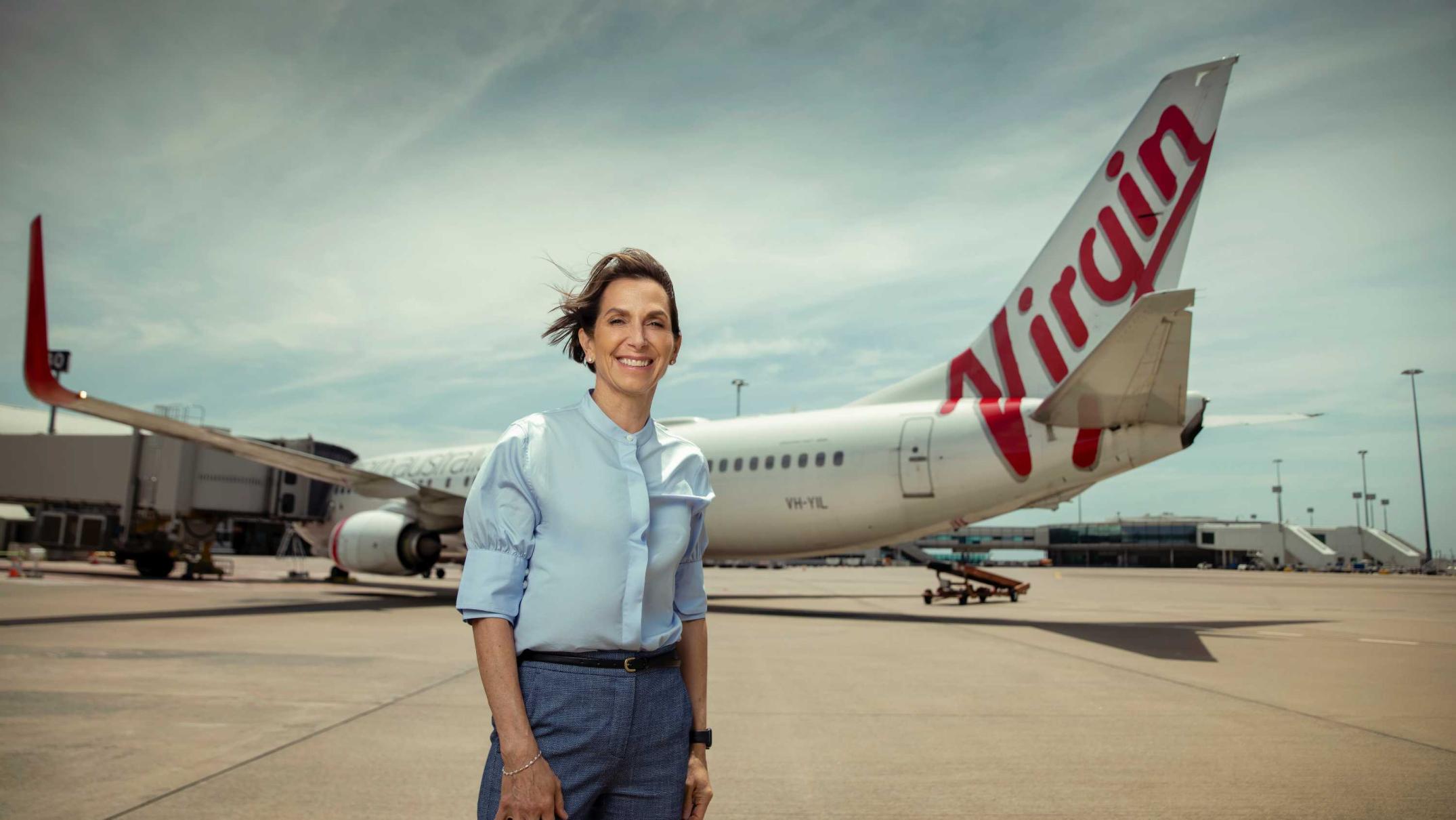 a woman standing in front of an airplane