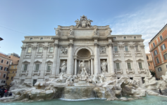 a large stone building with a fountain and statues with Trevi Fountain in the background