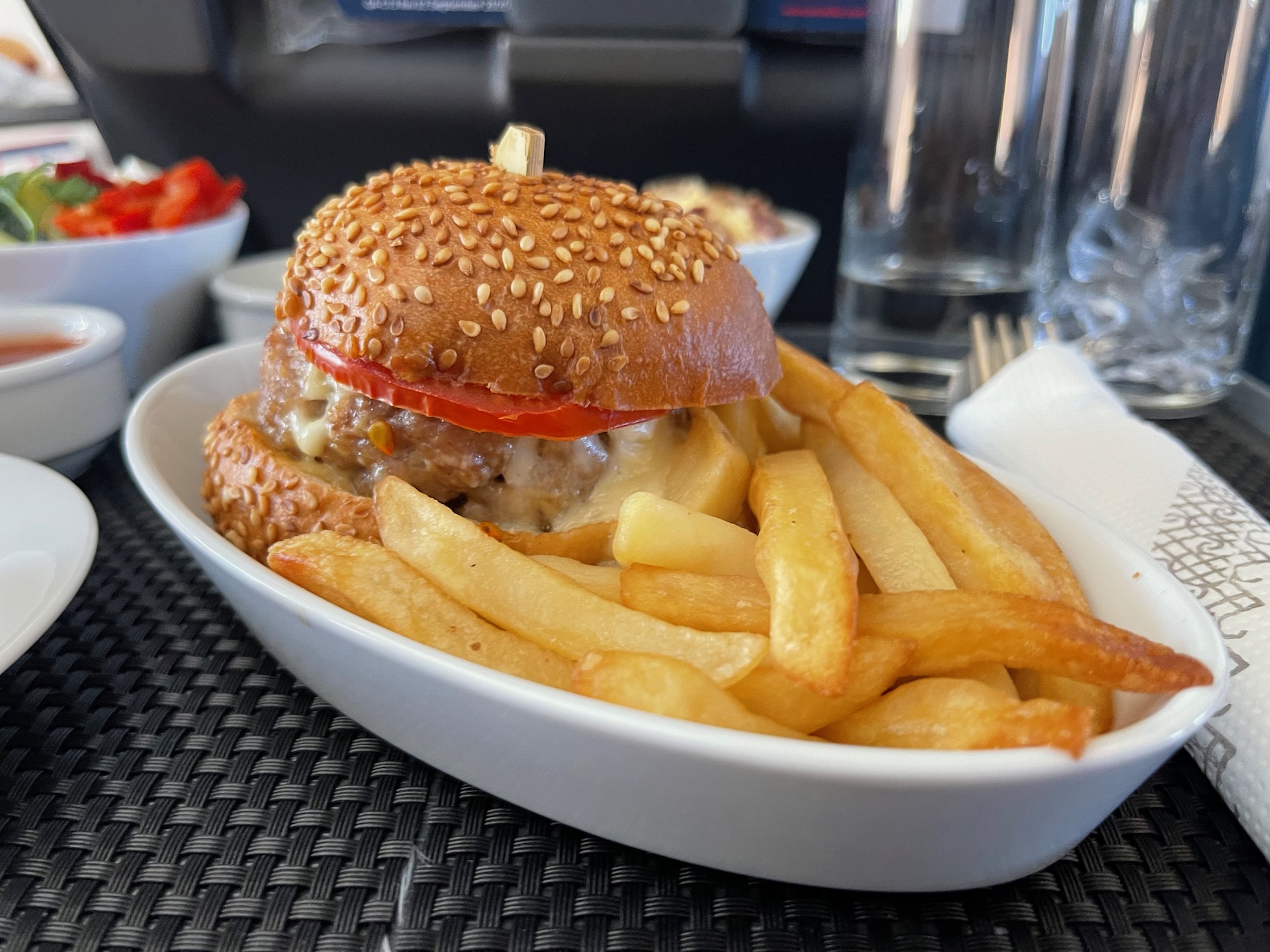 a burger and fries in a bowl