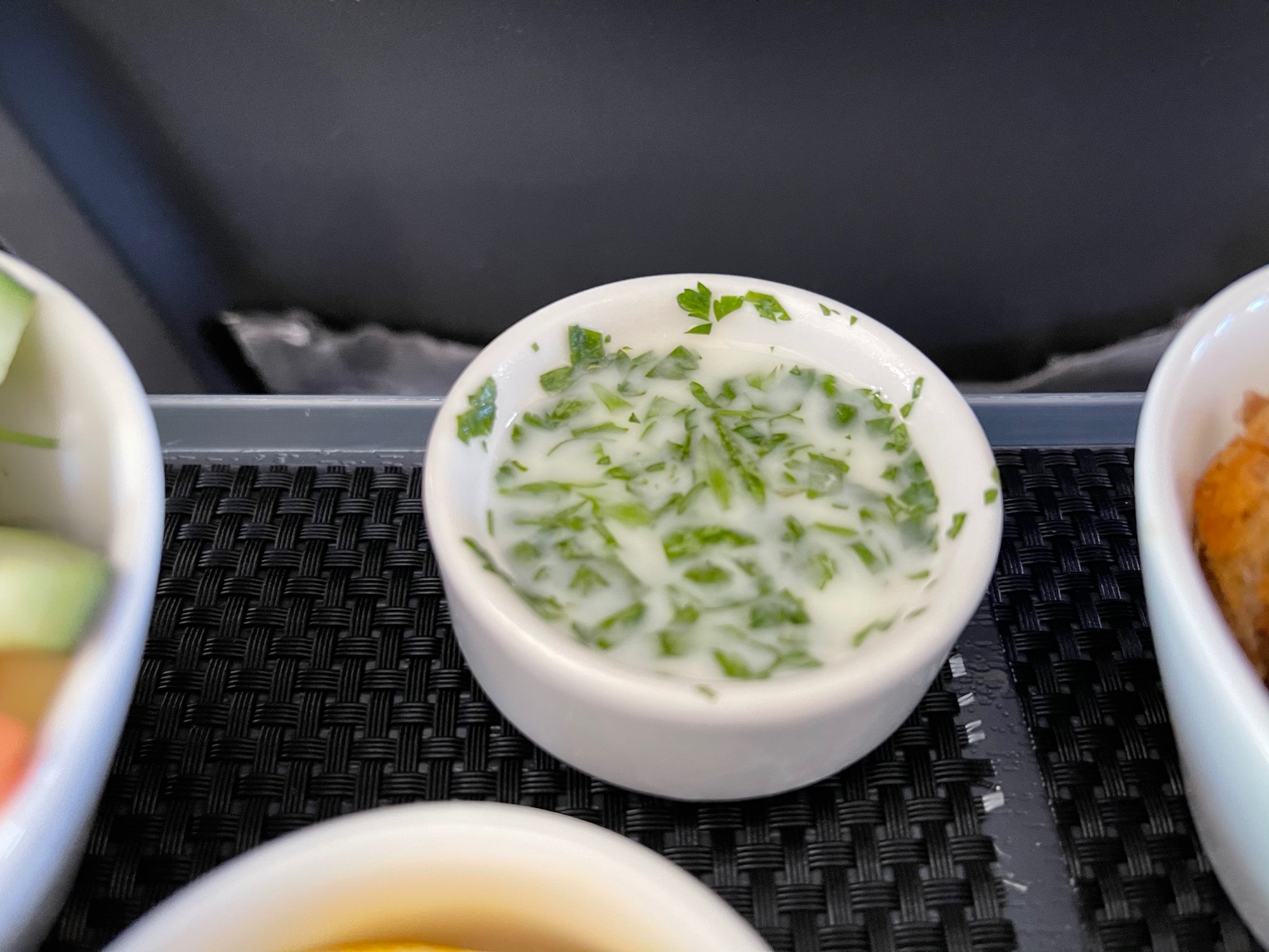 a bowl of soup with green leaves