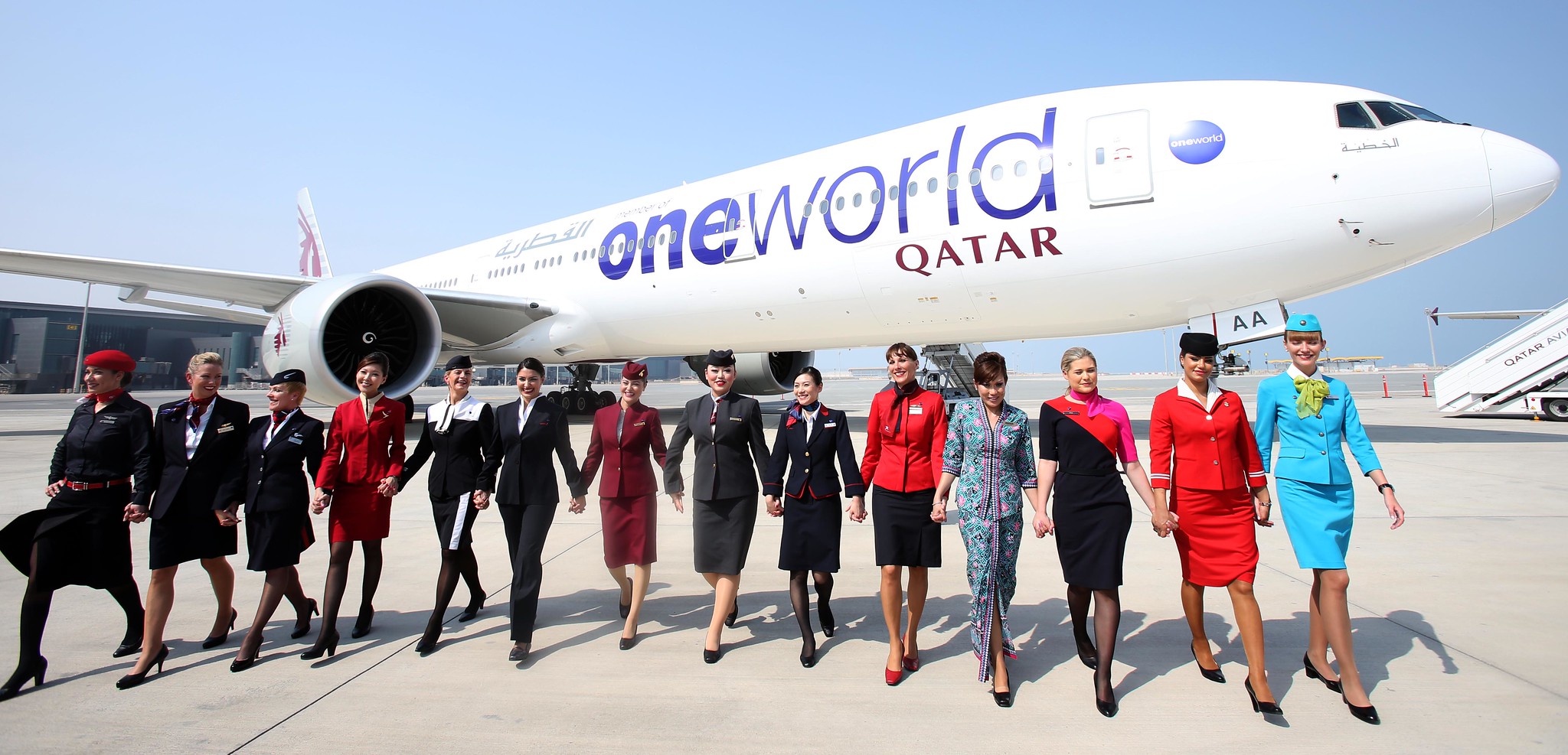 a group of people standing in front of a plane