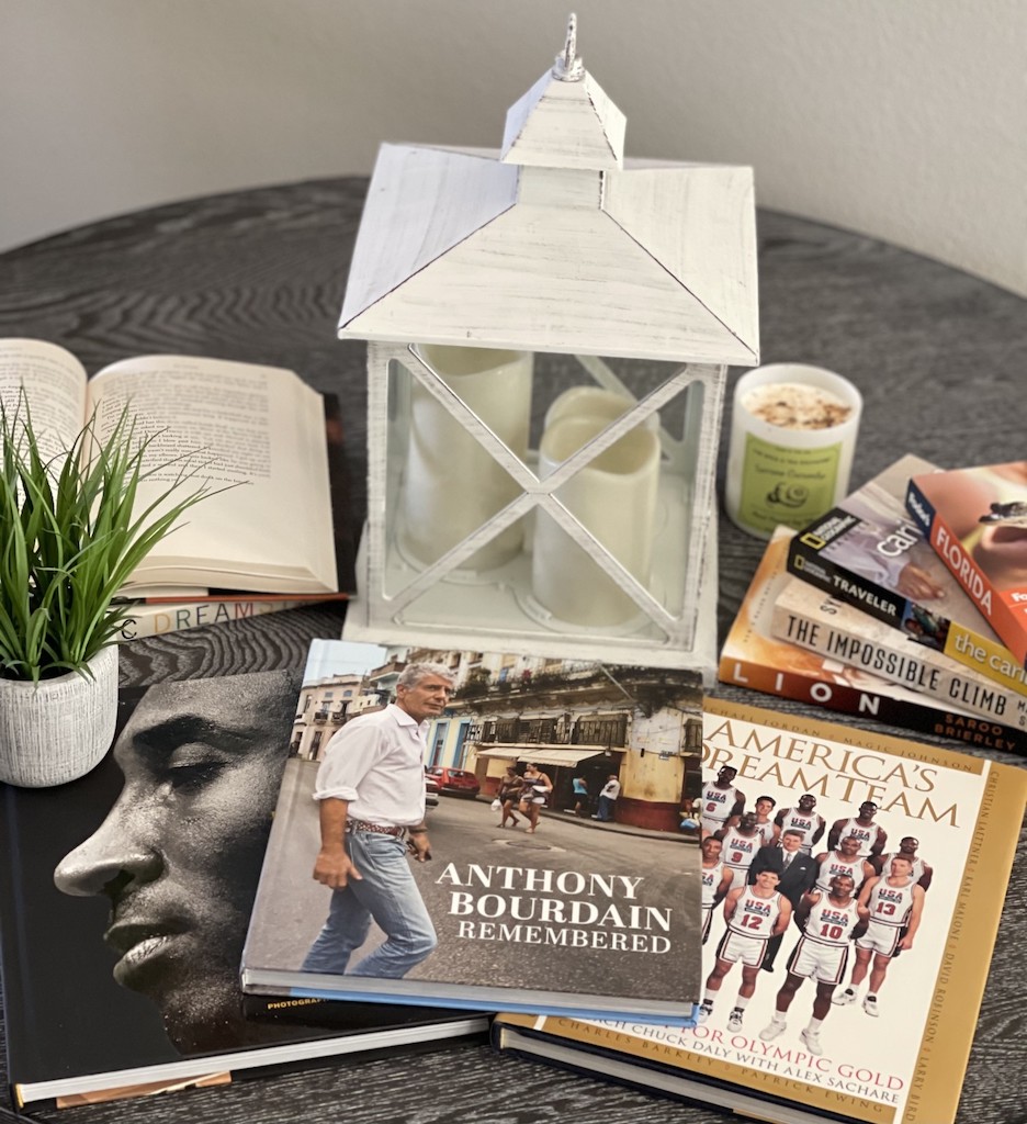 a white candle holder and books on a table
