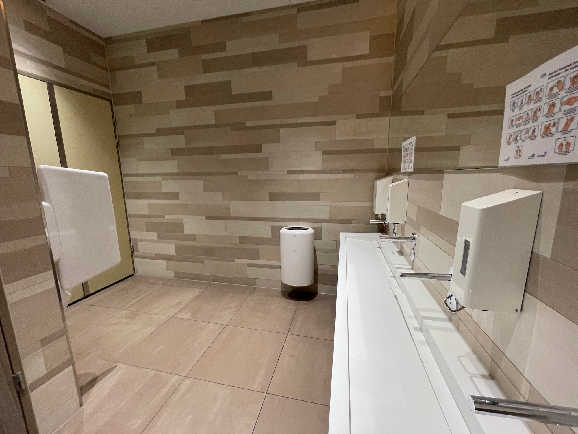 a bathroom with a urinal and urinals