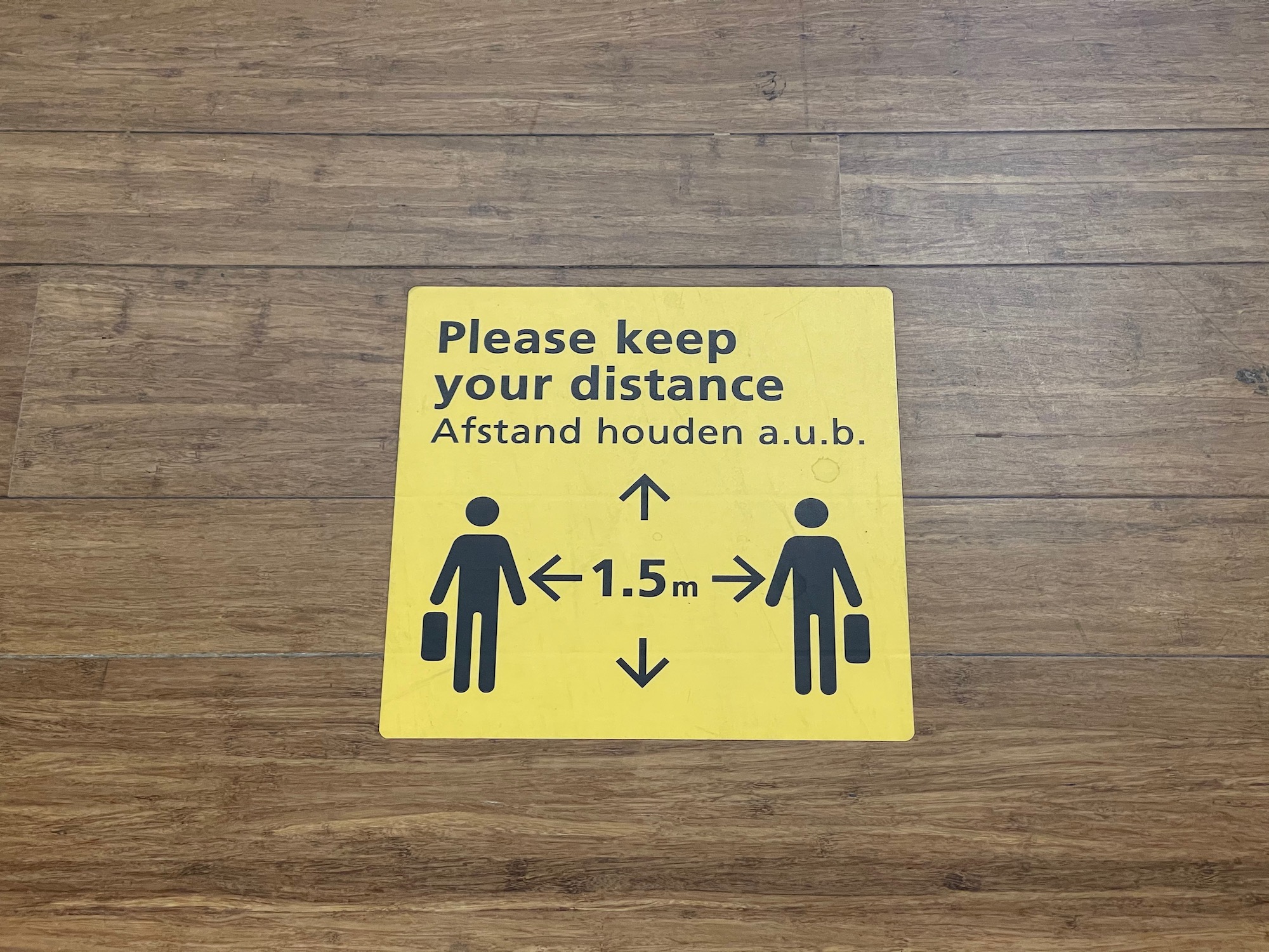 a yellow sign on a wood floor