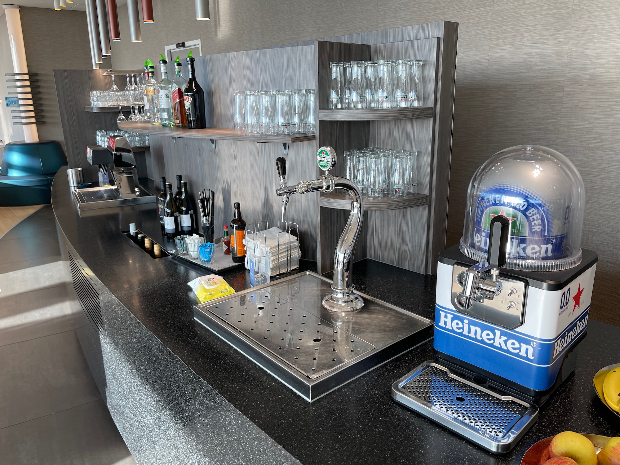 a bar with a tap and bottles on it