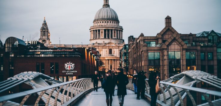 a group of people walking on a bridge