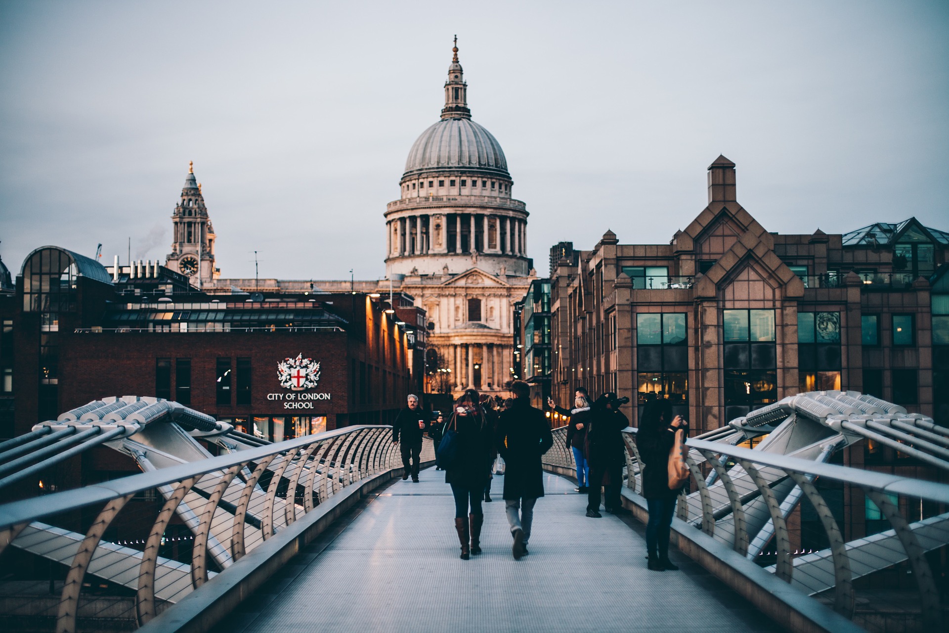 a group of people walking on a bridge