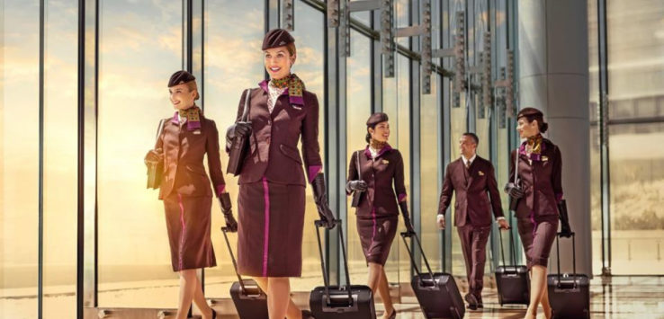 a group of stewardesses walking with luggage